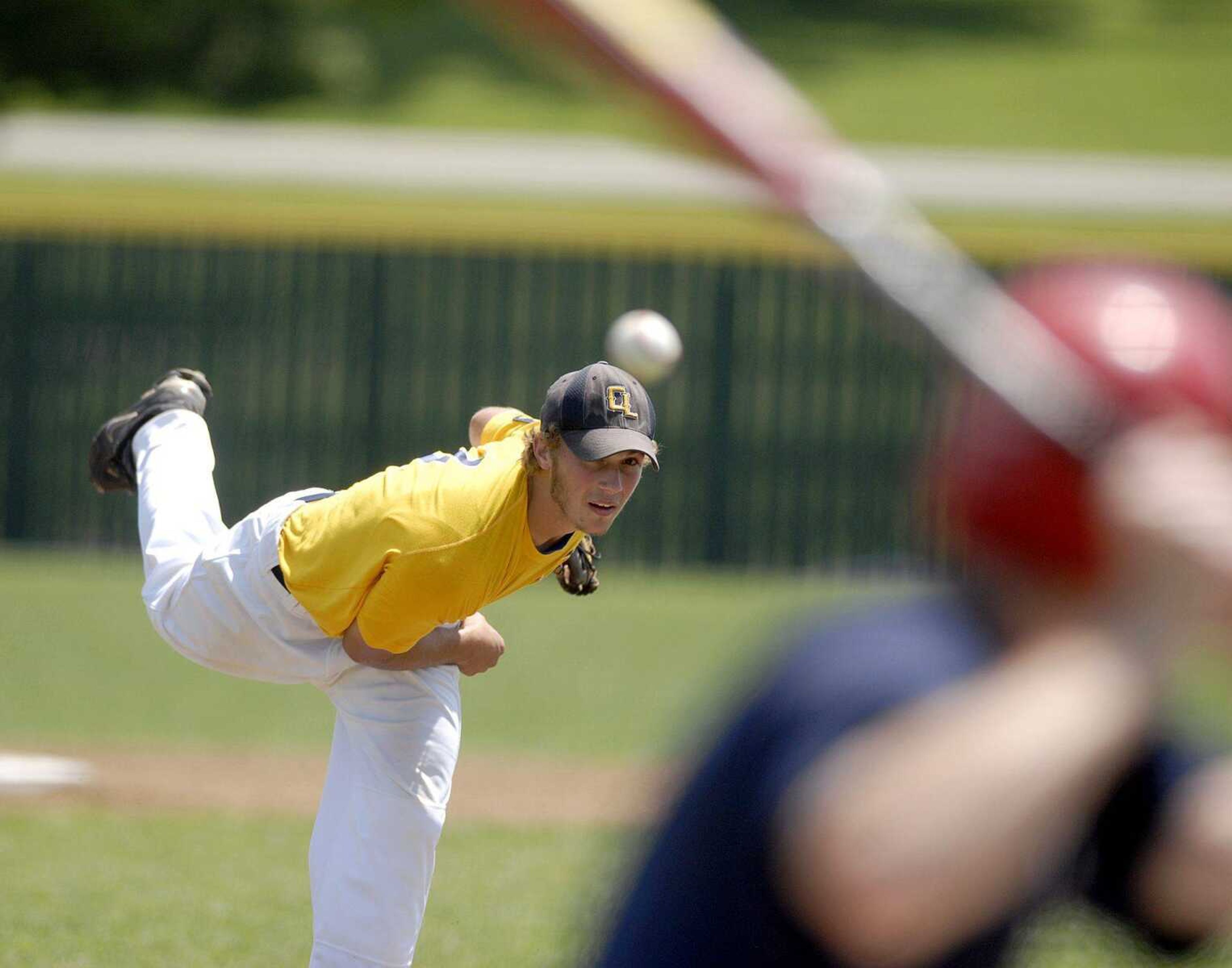 TOP: Cape Legion's Josh Henson delivers a pitch to a Festus batter during Friday's Zone 4 tournament game in Perryville. Festus won the game 12-1 in eight innings.LEFT: Cape's Jimmy Obermark leaps for a throw to third during the third inning.ELIZABETH DODD  edodd@semissourian.com