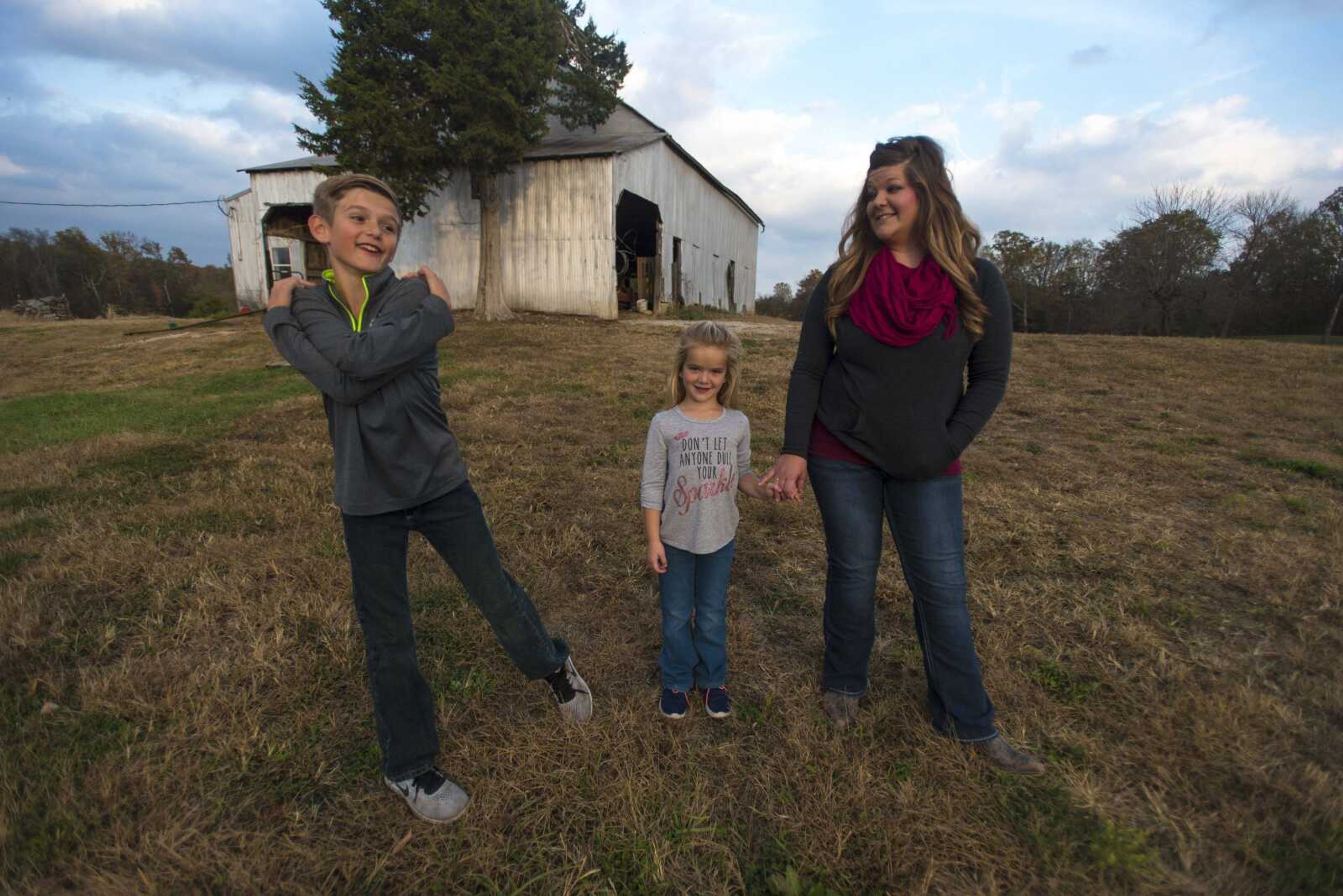 From left, Connor, Raelyn and Becky Moore stand in their yard Nov. 2 in Perryville, Missouri.