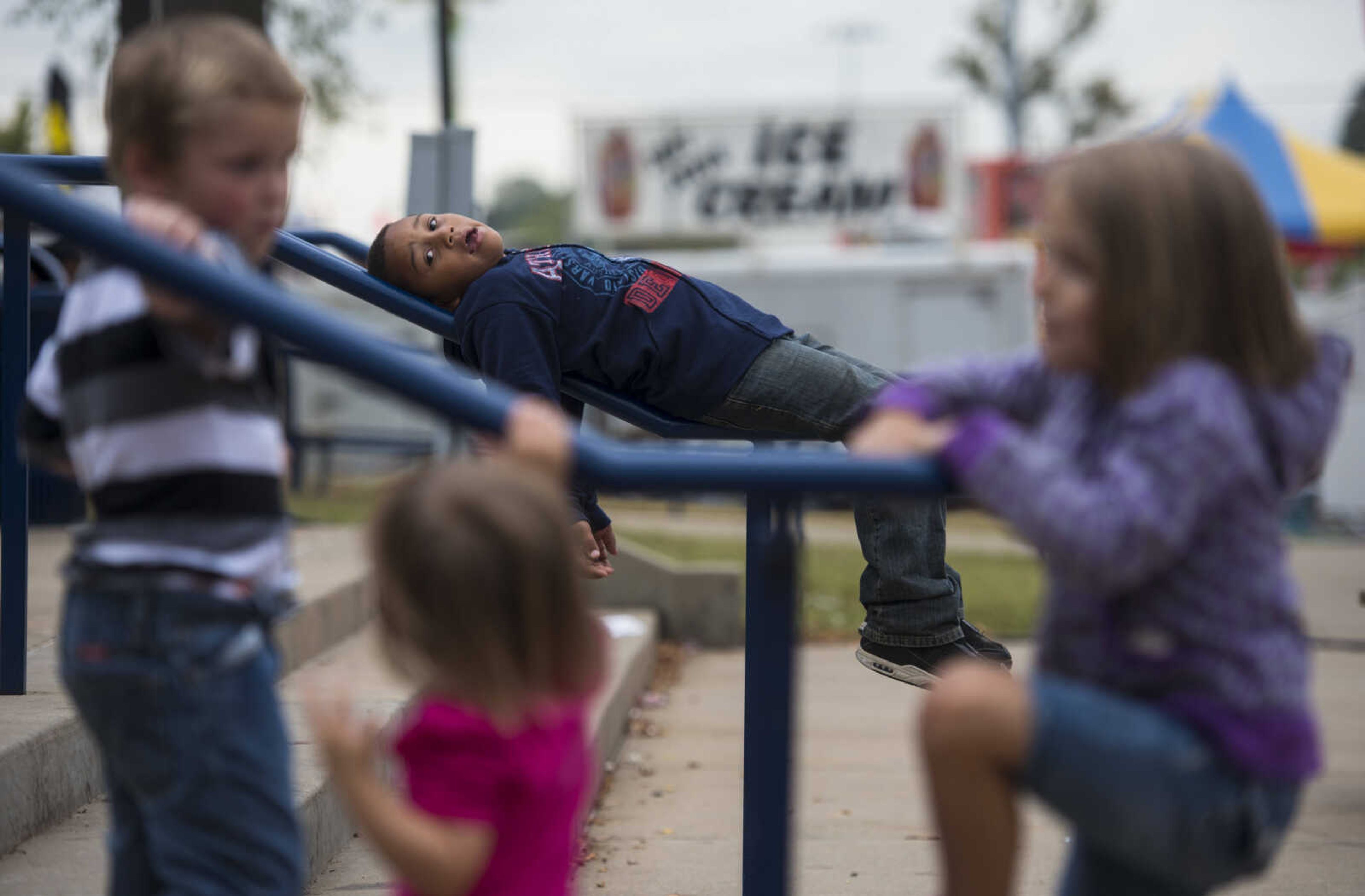 Deontae Gwinn, 5, lies on a handrail at the SEMO District Fair on September 12, 2017, in Cape Girardeau.