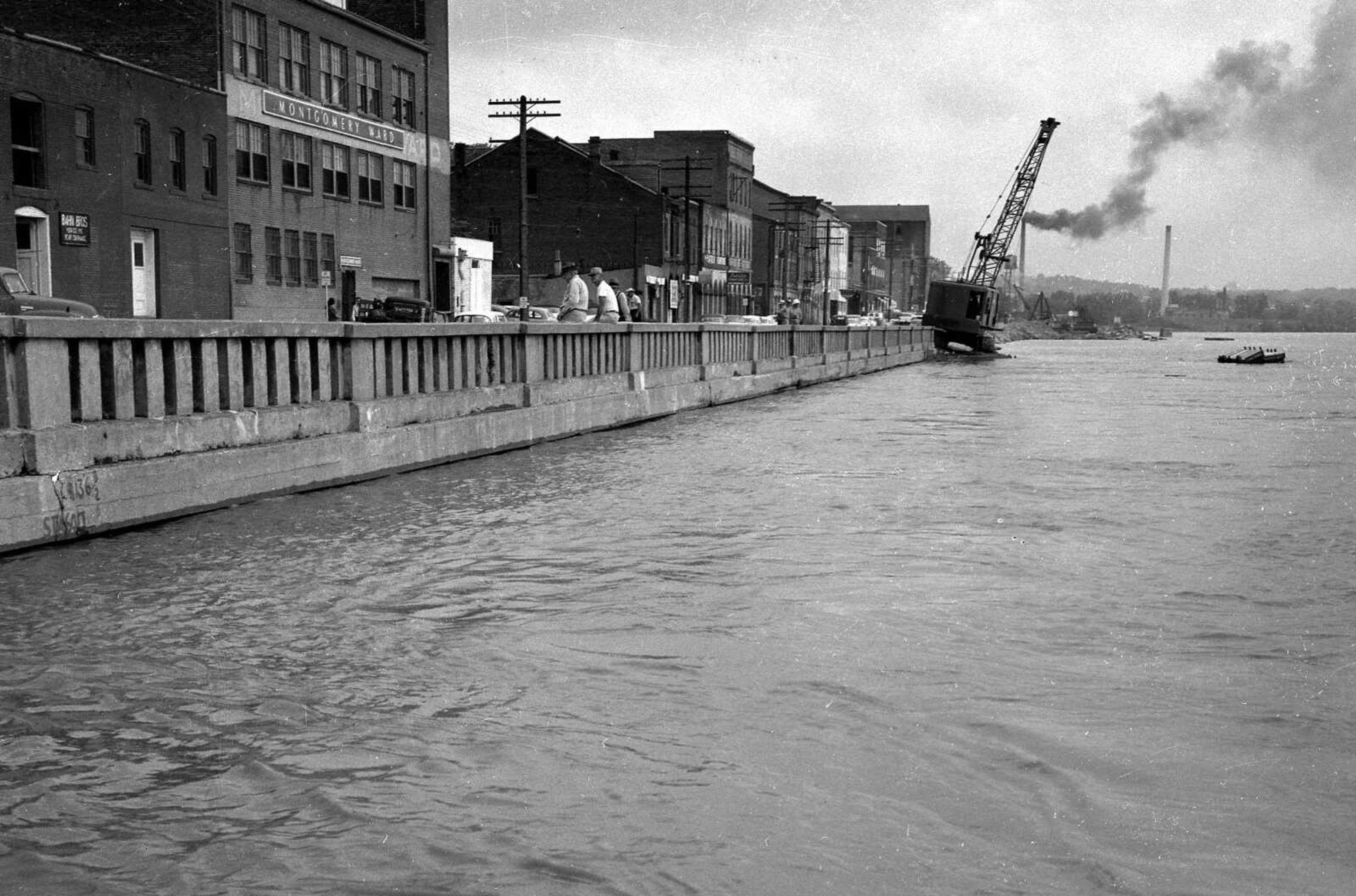 The flooding Mississippi river was at a virtual standstill on July 25, 1958, at a stage of 33.9 feet. This view of Water Street, looking north, provides a good view of what is known as the "Frisco sea wall."