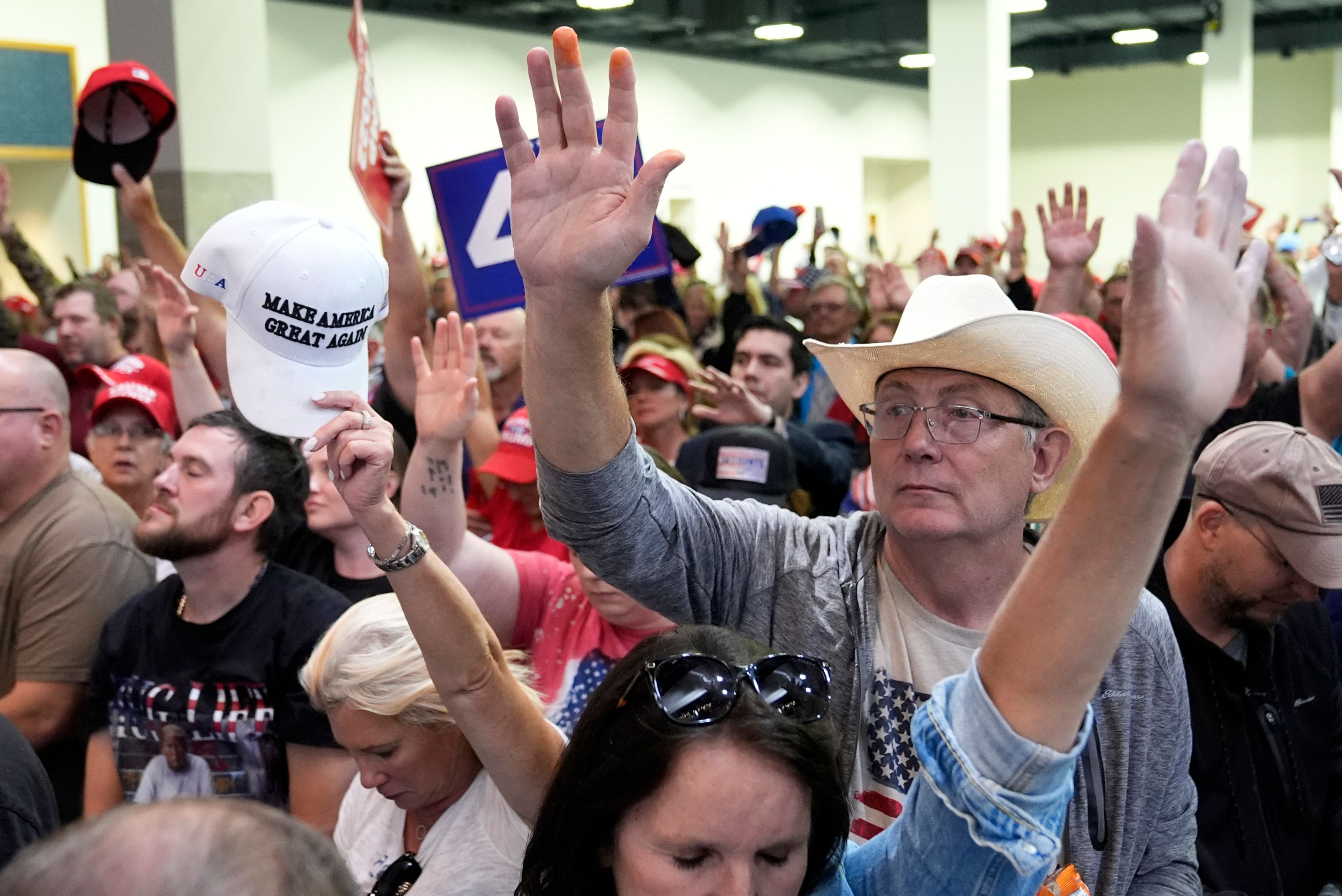 Supporters pray before Republican presidential nominee former President Donald Trump speaks at a campaign rally at the Gaylord Rockies Resort & Convention Center, Friday, Oct. 11, 2024, in Aurora, Colo. (AP Photo/Alex Brandon)