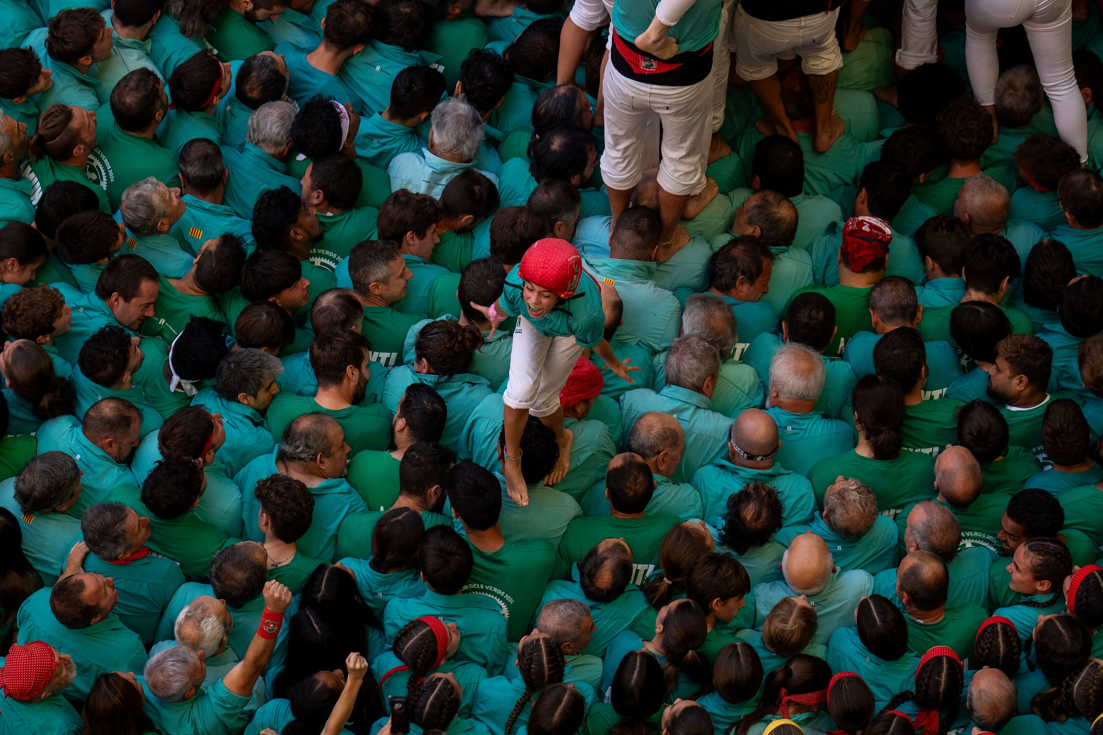 A member of "Castellers de Vilafranca" reacts after completing a "Castell" or human tower, during the 29th Human Tower Competition in Tarragona, Spain, Sunday, Oct. 6, 2024. (AP Photo/Emilio Morenatti)