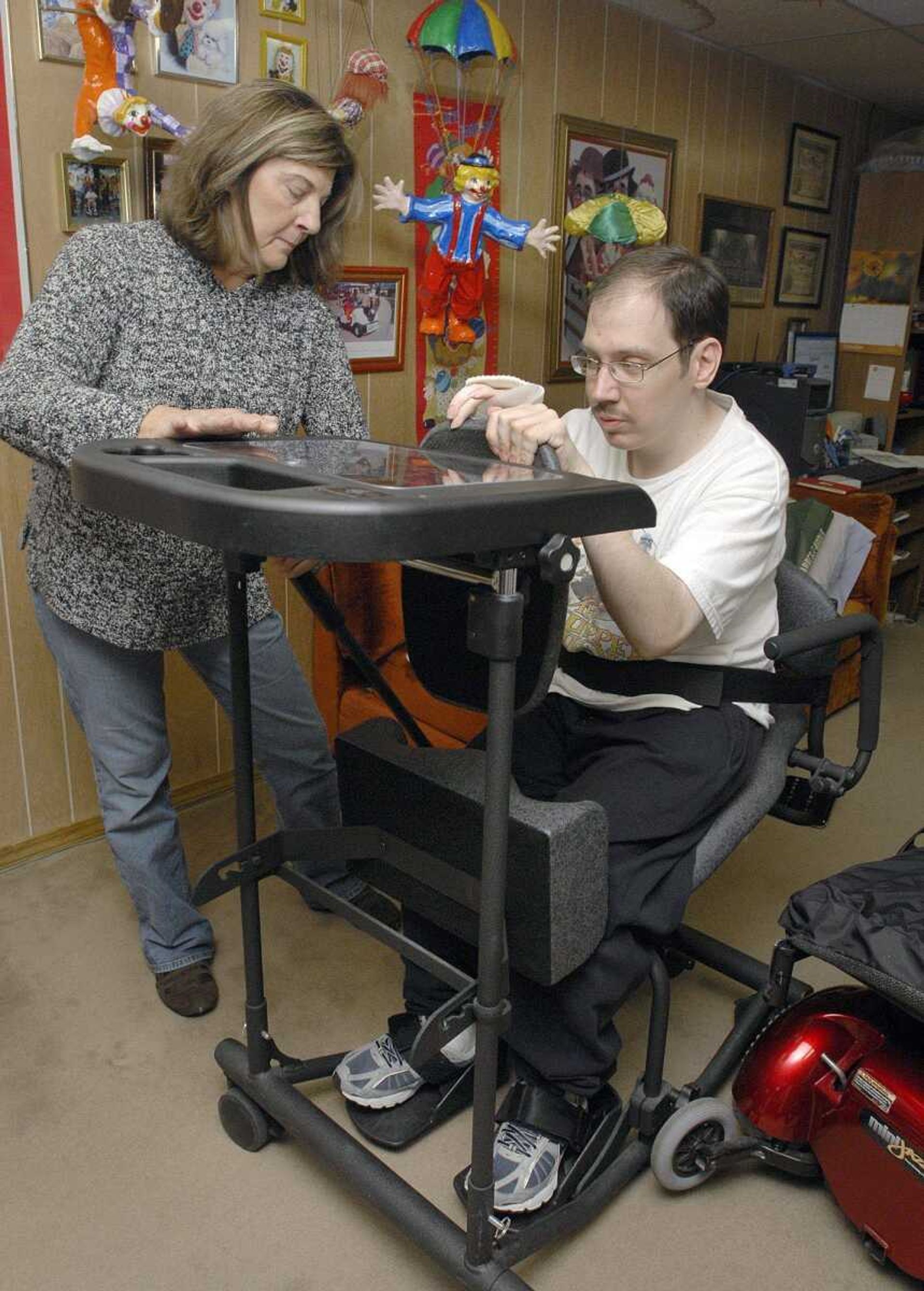 FRED LYNCH ~ flynch@semissourian.com
Janet Miller assists Shane Sinn as he transfers from a wheelchair to a stander in his home. Miller works with Sinn five days a week.