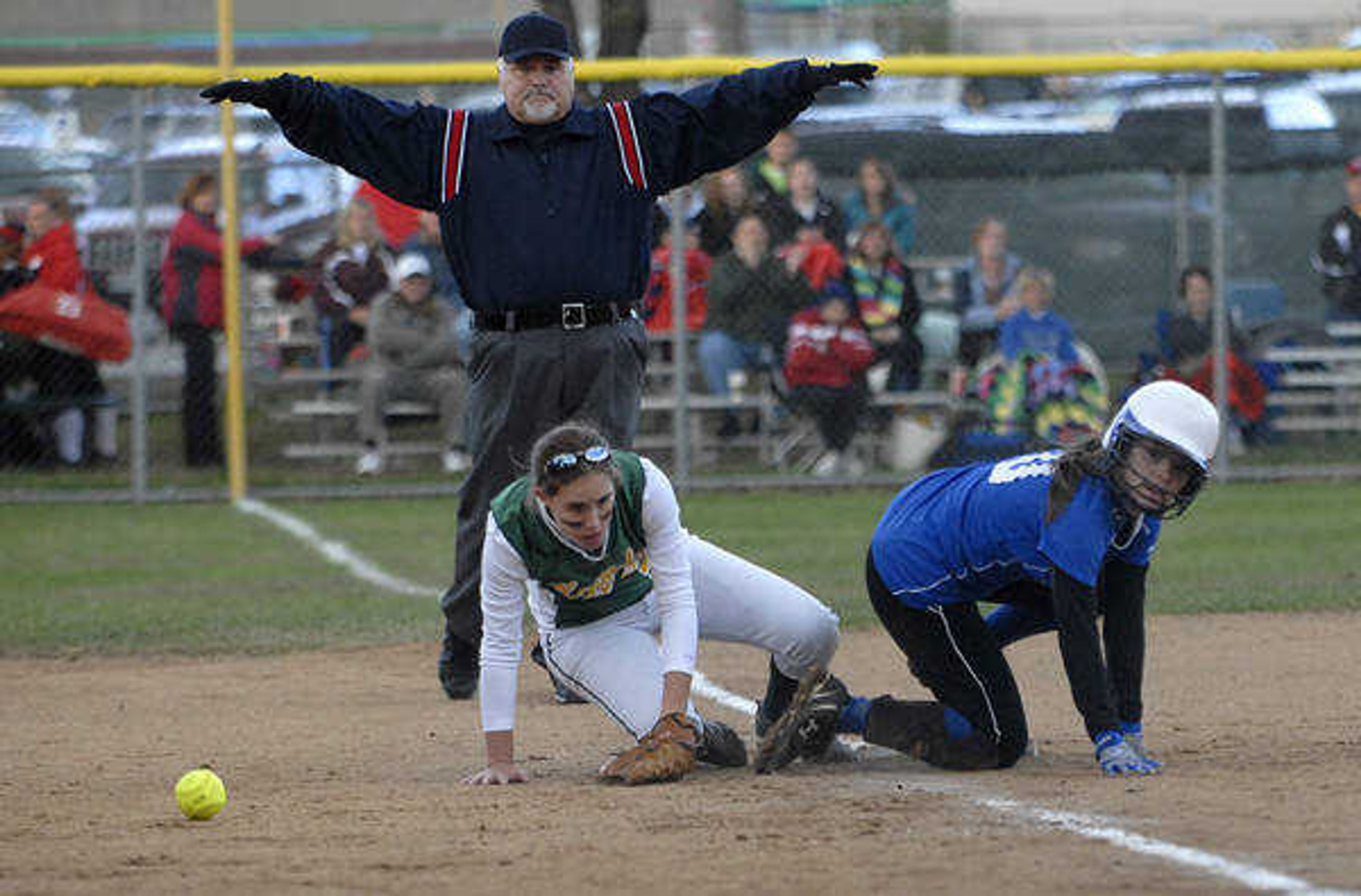 KIT DOYLE ~ kdoyle@semissourian.com
Notre Dame's Mallory Siebert glances up while being called safe on a pickoff play as the ball got away from Kennedy's Jenny Hill Saturday afternoon, October 17, 2009, in Ballwin.