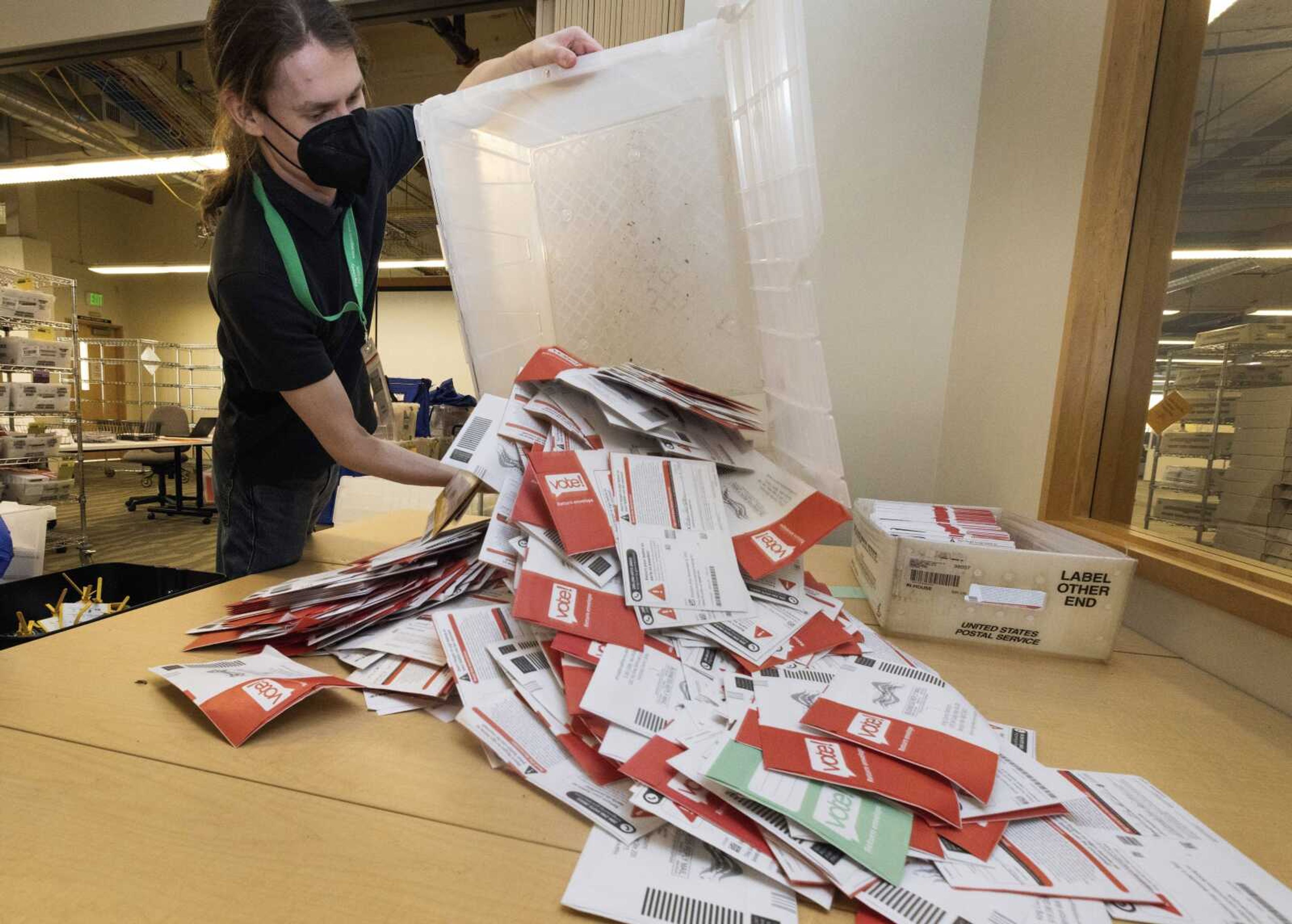 Election worker Patrick Schmeichel prepares to process ballots that just arrived from a ballot drop-box on Election Day at the King County Elections headquarters Tuesday, Nov. 8, in Renton, Washington.