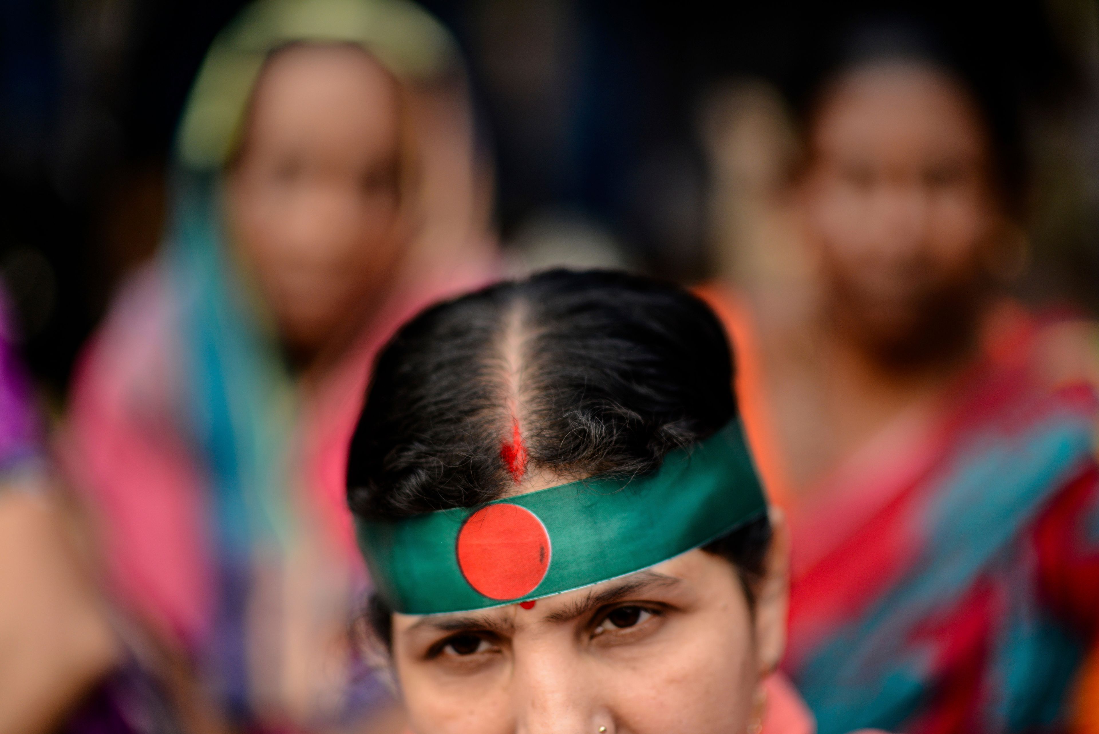 A Bangladesh Hindu wears a headband in the colors of Bangladesh's national flag during a protest rally to demand that an interim government withdraw all cases against their leaders and protect them from attacks and harassment in Dhaka, Bangladesh, Saturday, Nov. 2, 2024. (AP Photo/Mahmud Hossain Opu)