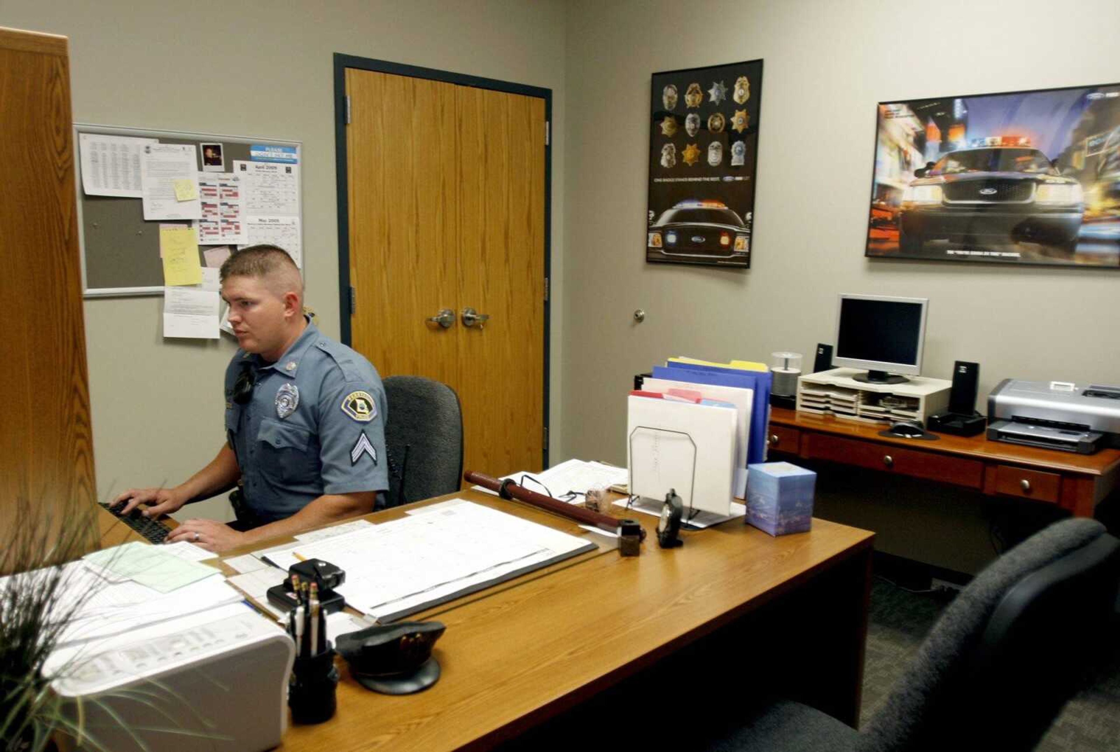 Cpl. Brad Pitts works in the new traffic division office that he shares with one other officer in May 2009 in the new Perryville police station. Pitts said the traffic division did not have an office in the last building. (Elizabeth Dodd)