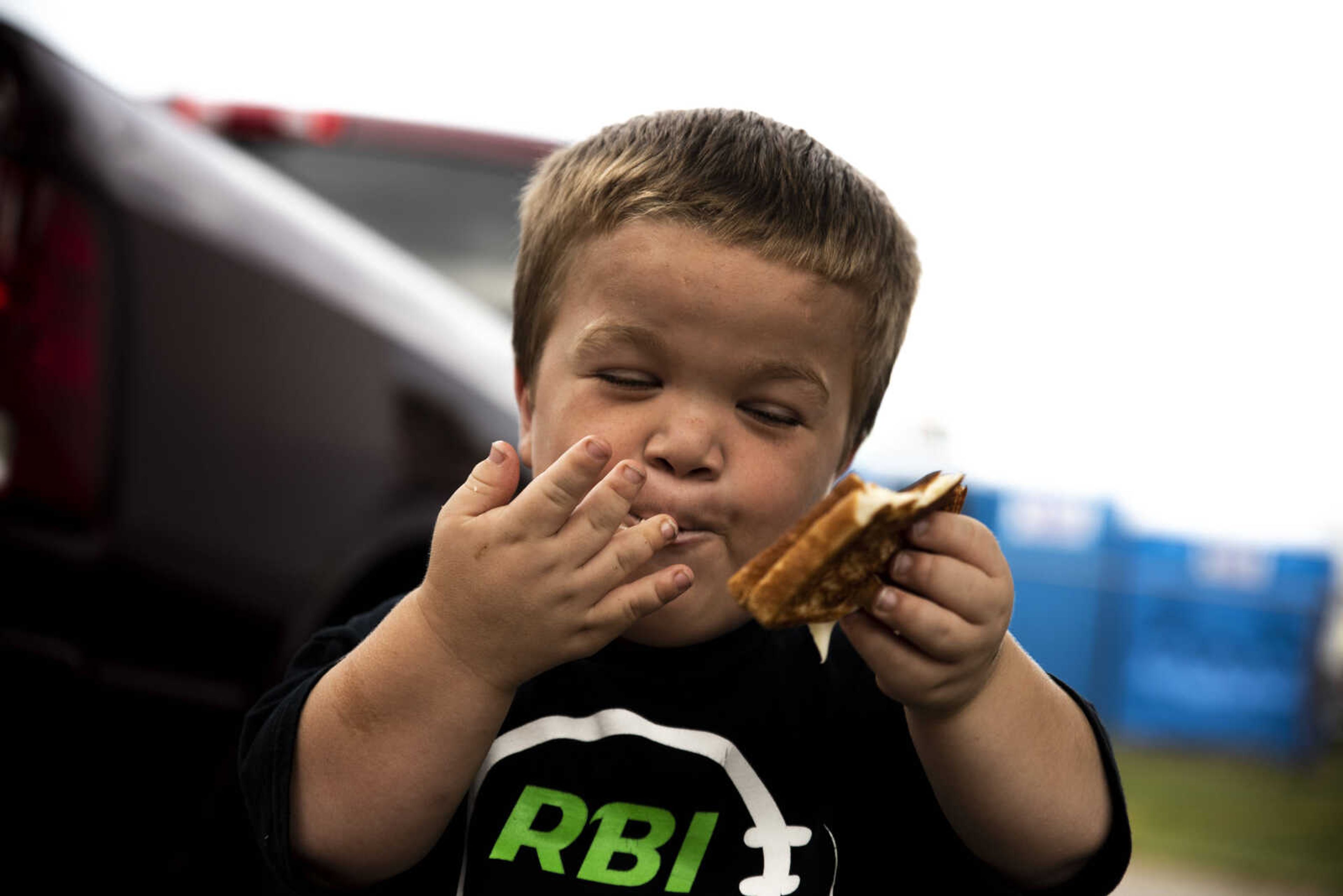 Izaac Pursley enjoys a grilled cheese sandwich while at the East Perry Community Fair Sept. 21, 2018, in Altenburg.