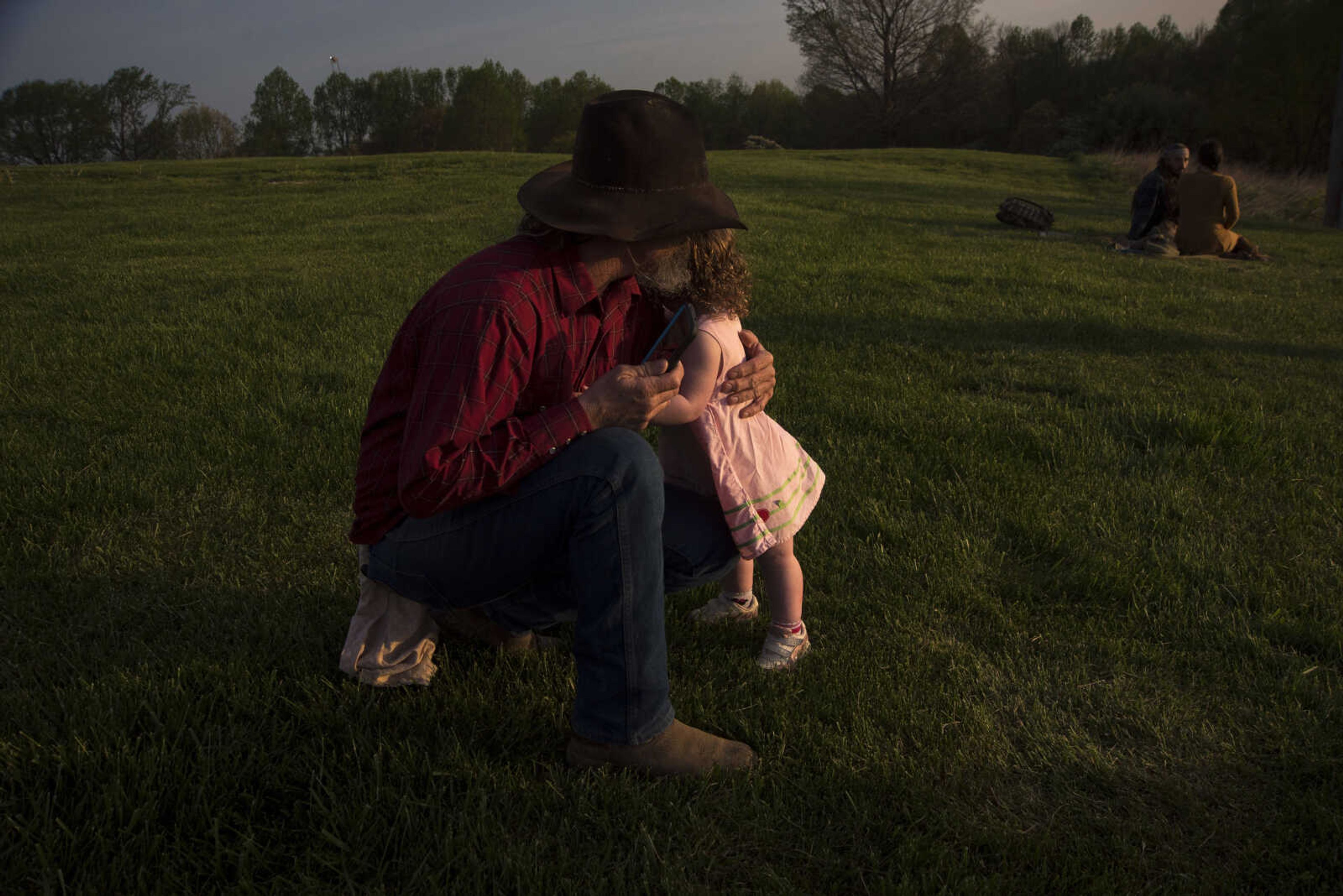 Chris Powers holds onto his daughter Amelia Gilliland before taking a photo during the 81st annual Easter Sunrise Service at the Bald Knob Cross of Peace Sunday, April 16, 2017 in Alto Pass, Illinois.