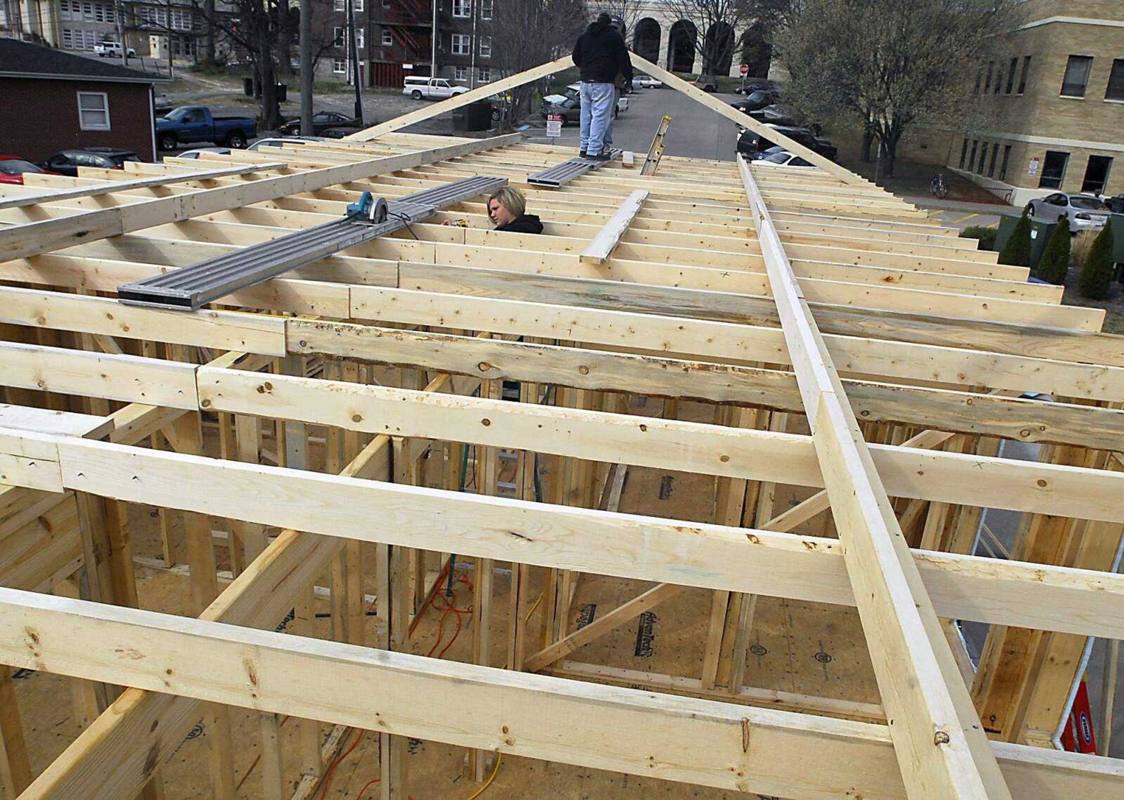 KIT DOYLE ~ kdoyle@semissourian.com
Volunteer Amy Pinter screws in ceiling beams at the Habitat for Humanity home being built in the Alumni Center parking lot Wednesday, March 11, 2009, in Cape Girardeau.