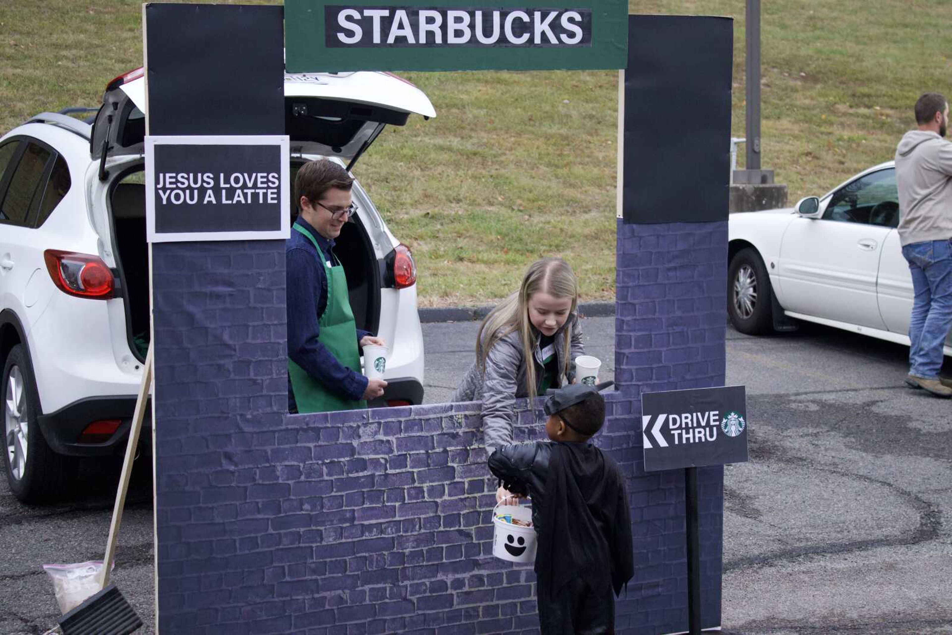 Caleb and Kyndal Strickland dressed up as Starbucks workers at their makeshift 
Starbucks drive-thru on Monday, Oct. 31 at Lynwood Baptist Church. They passed out candy from Starbucks coffee cups. 
(Photo by Jeffery Long)