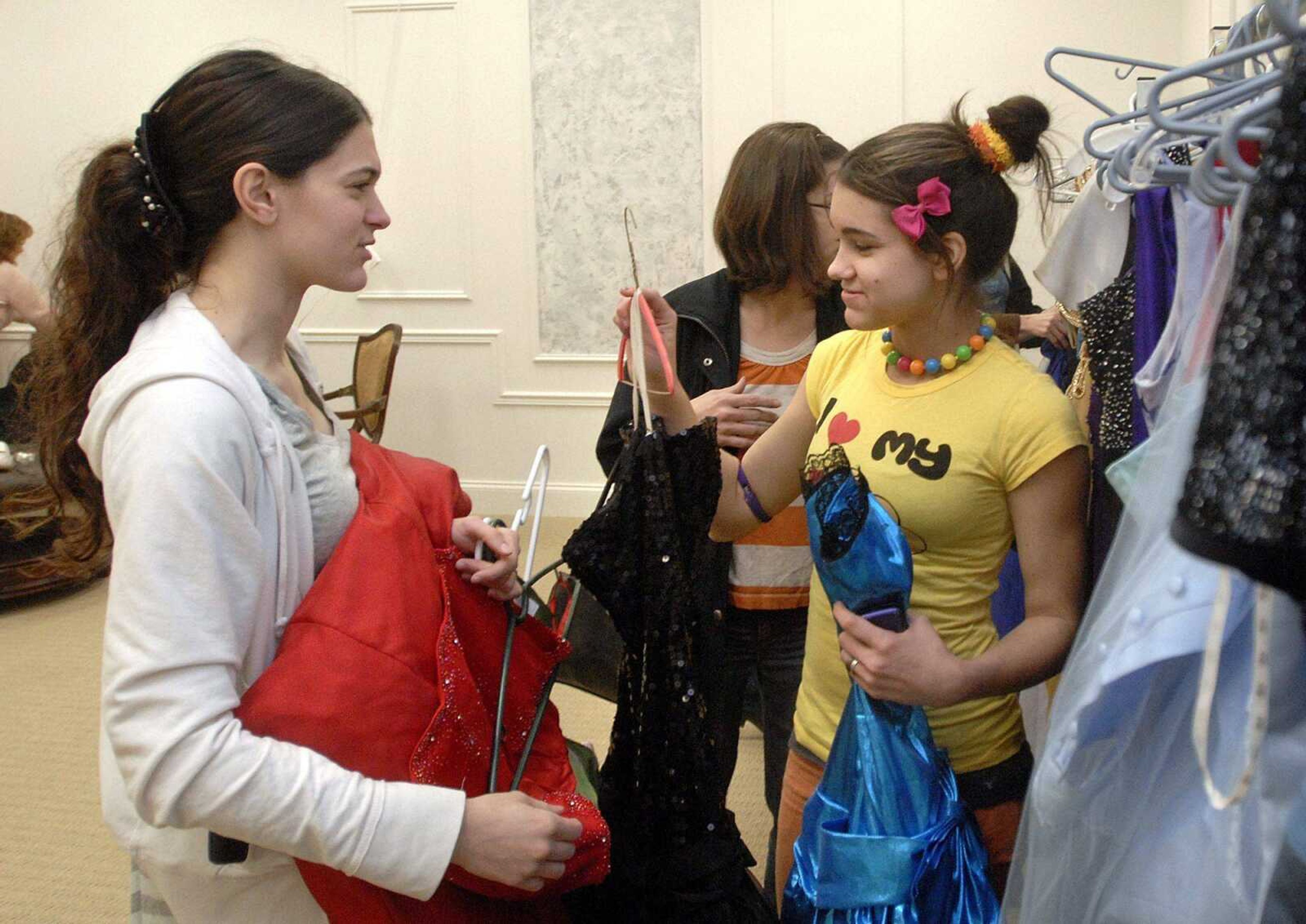 Sisters Tessa, left, and Jackie McNally pick out dresses to try on Sunday, March 7, 2010 during the March of Dimes fundraiser "Ballgowns for Babies" at The Venue in Cape Girardeau. The fundraiser features used and donated gowns for under $100. The March of Dimes works to improve the health of babies by preventing birth defects, premature birth, and infant mortality. (LAURA SIMON)