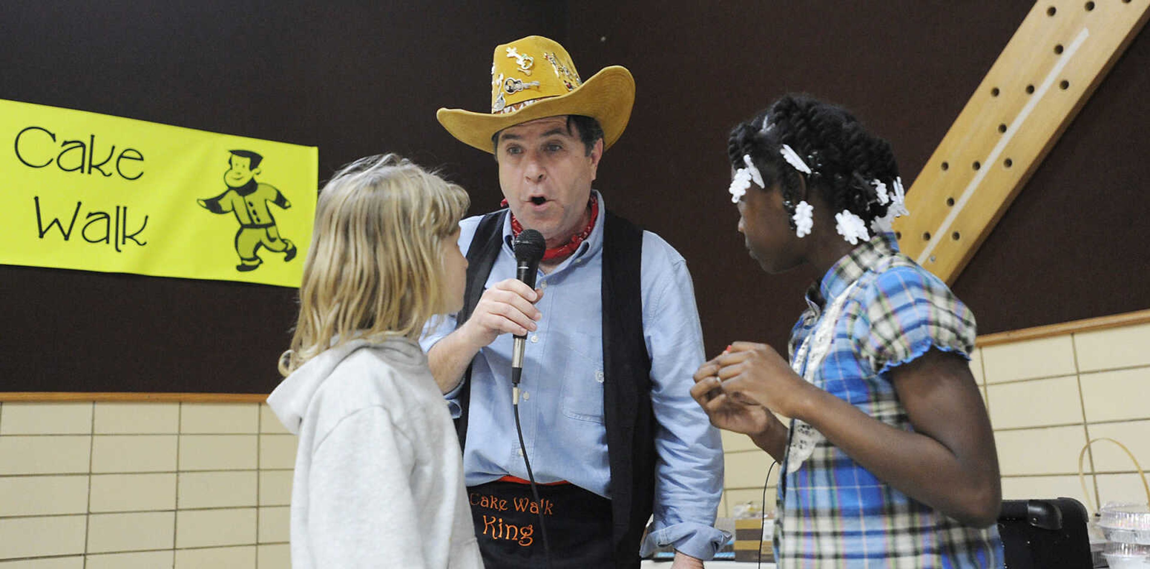 Principal Mark Cook announces the winner during a round of cake walking during the Jefferson Elementary Chili Dinner Friday night. Cook is retiring after this year.