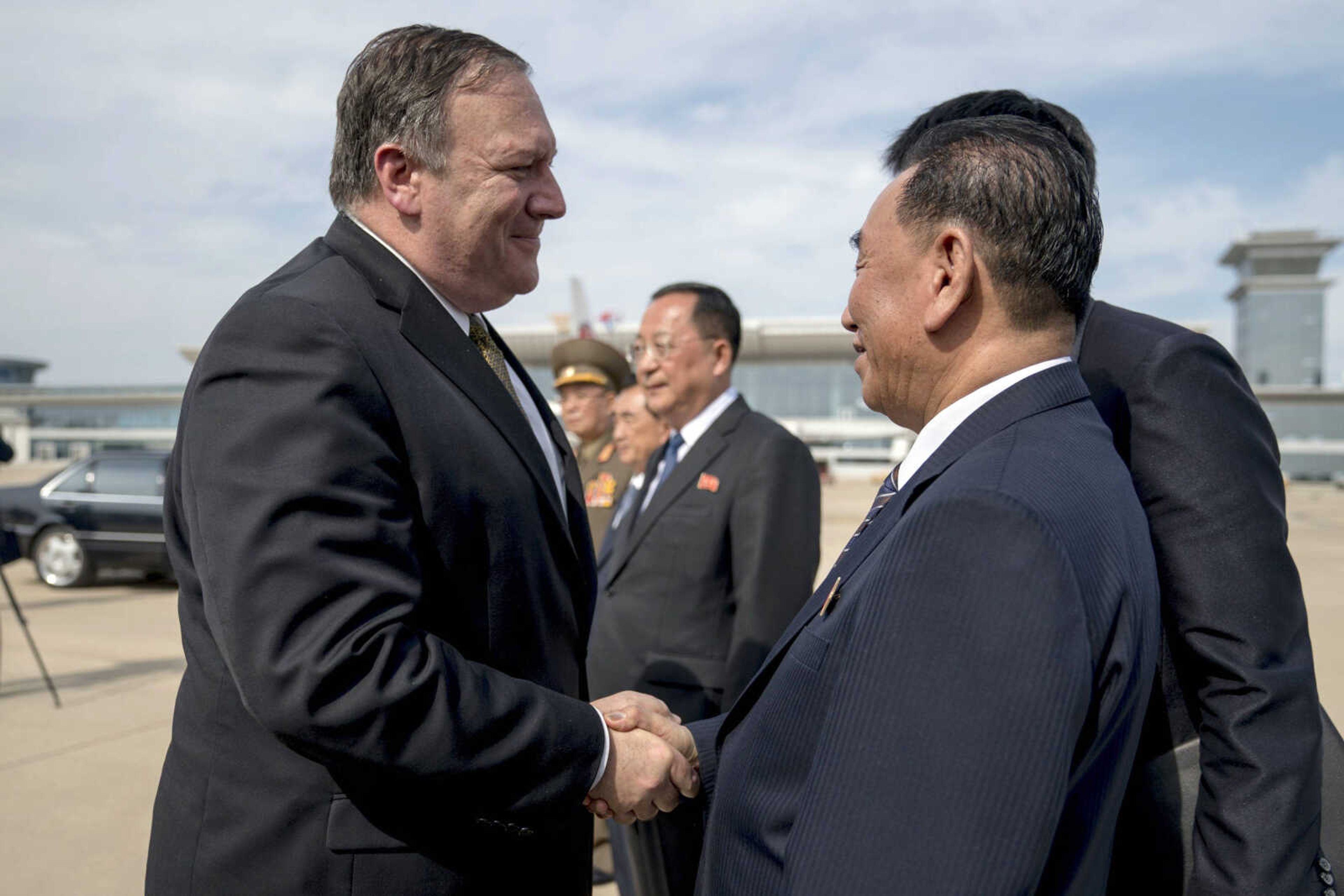 U.S. Secretary of State Mike Pompeo, left, says goodbye to Kim Yong Chol, right, a North Korean senior ruling party official and former intelligence chief, on Saturday before boarding his plane at Sunan International Airport in Pyongyang, North Korea, to travel to Japan.