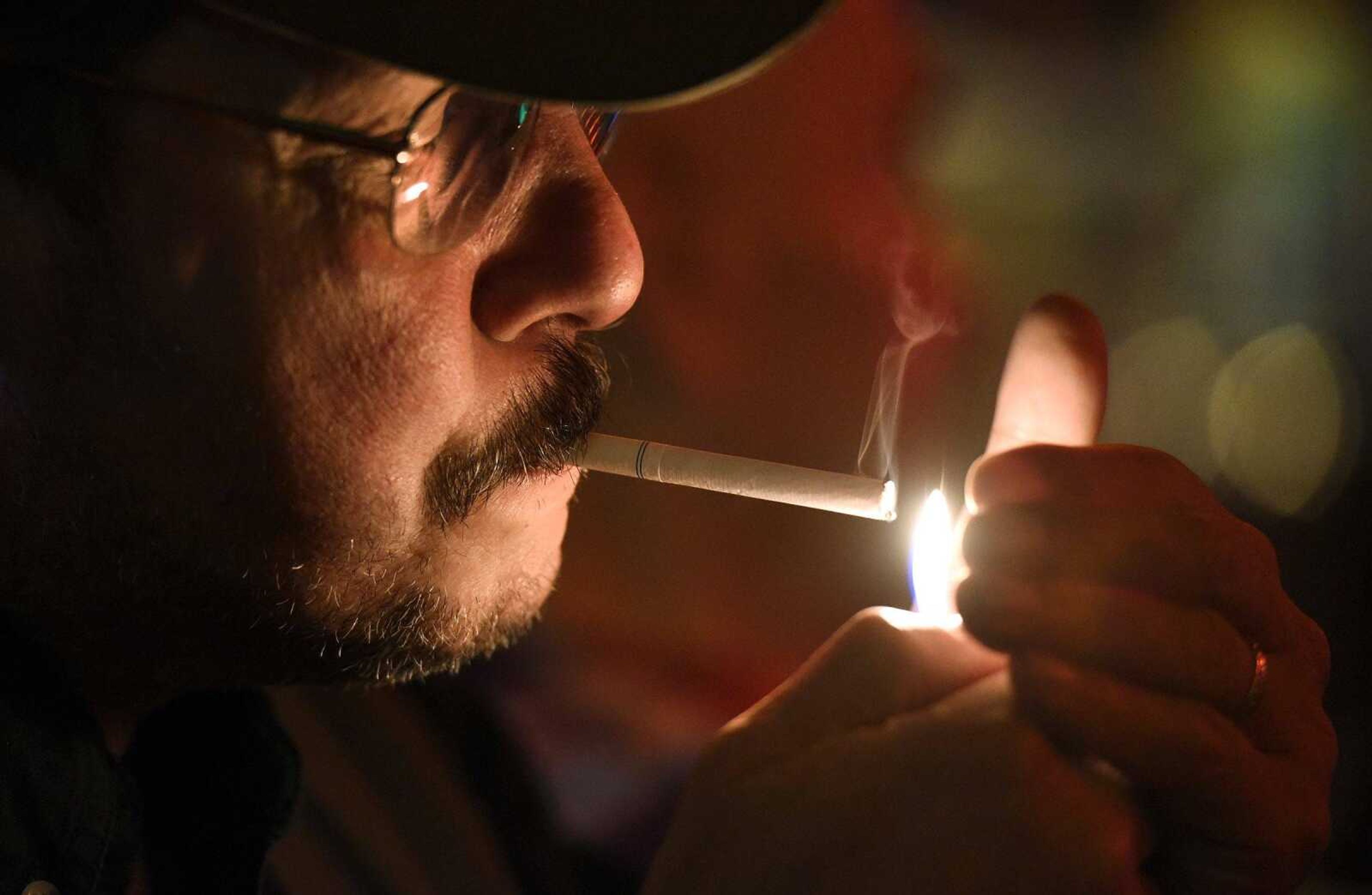 Jim Barbatti lights a cigarette Thursday at Rude Dog Pub in downtown Cape GIrardeau.