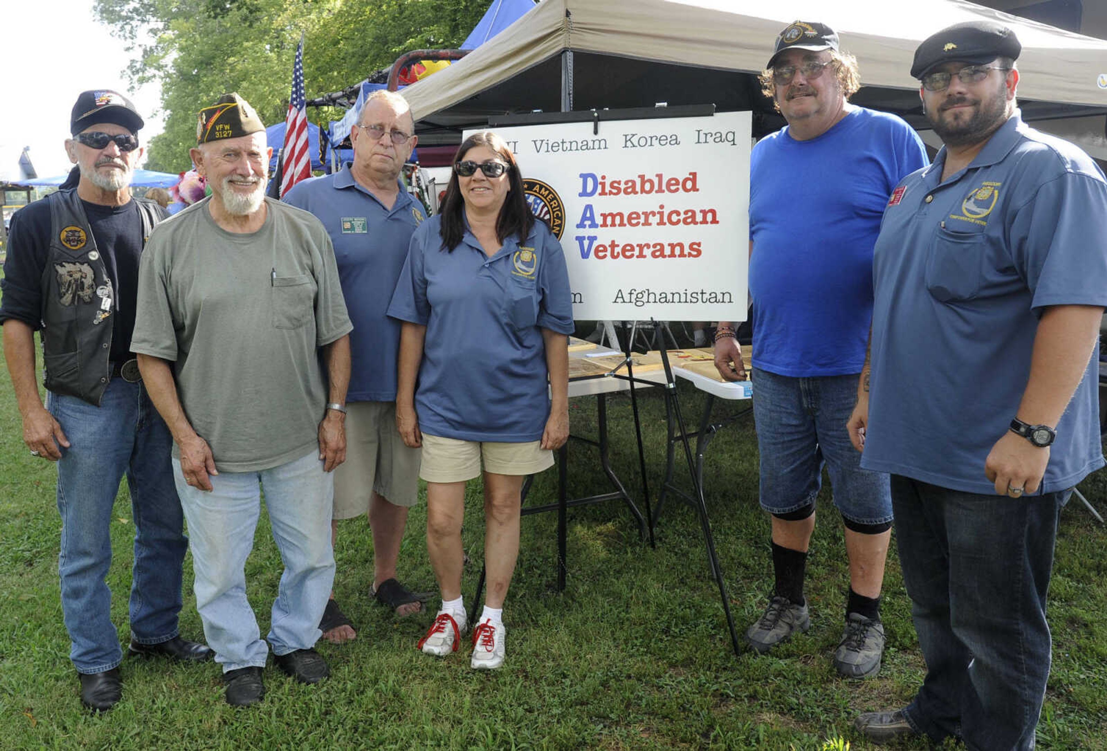 Rick McGuire, left, Marvin A. LeGrand, Joe Mohorc, and Barbara Simpson, with Chaffee VFW Post 3127, Russell Smith with Disabled American Veterans, and Tony Mohorc with Post 3127, pose for a photo at German Days on Saturday, Aug. 9, 2014 at Frisco Park in Chaffee, Missouri.