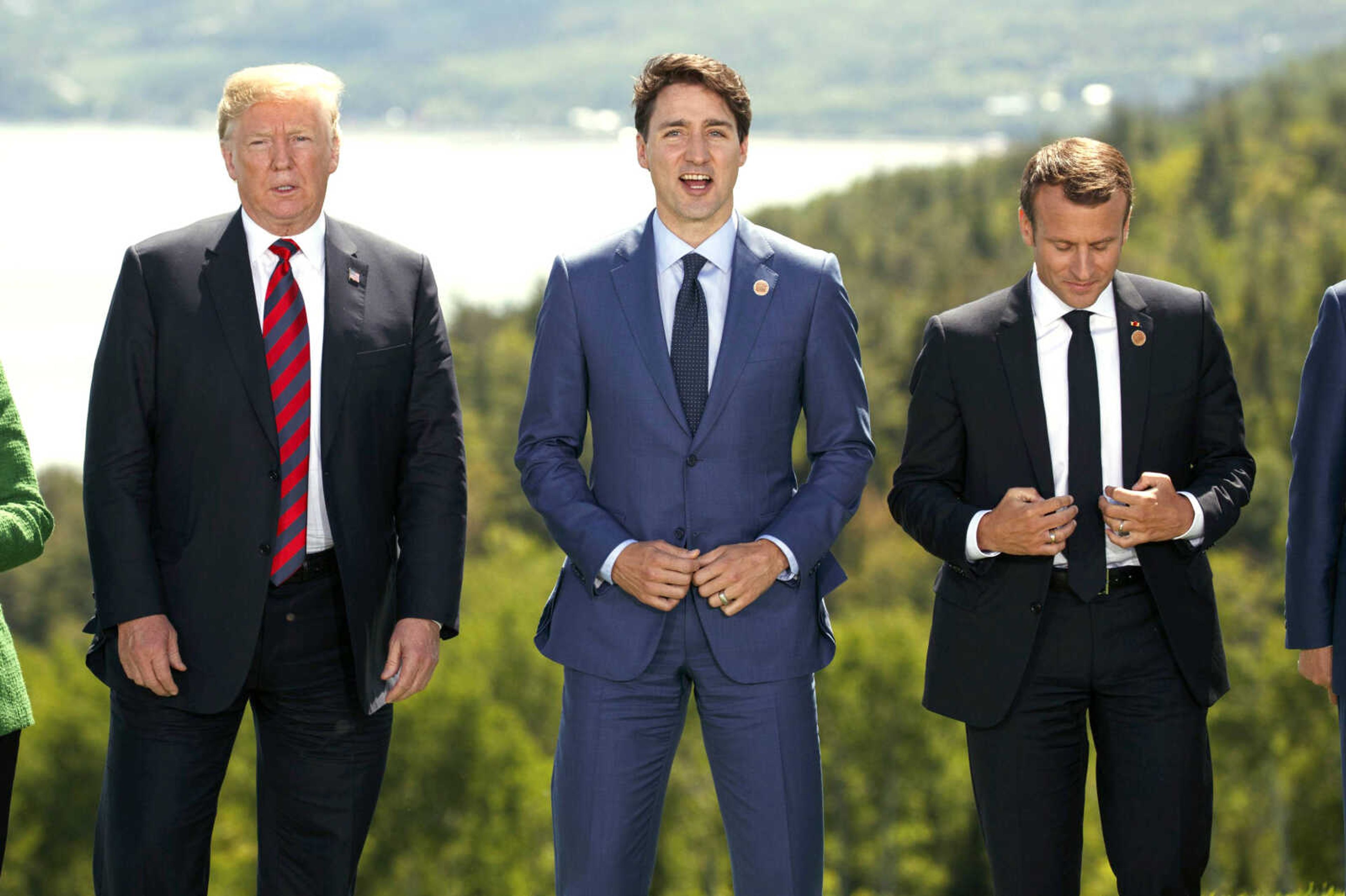 President Donald Trump, Canadian Prime Minister Justin Trudeau and French President Emmanuel Macron participate in the "family photo" Friday during the G-7 summit in Charlevoix, Canada.