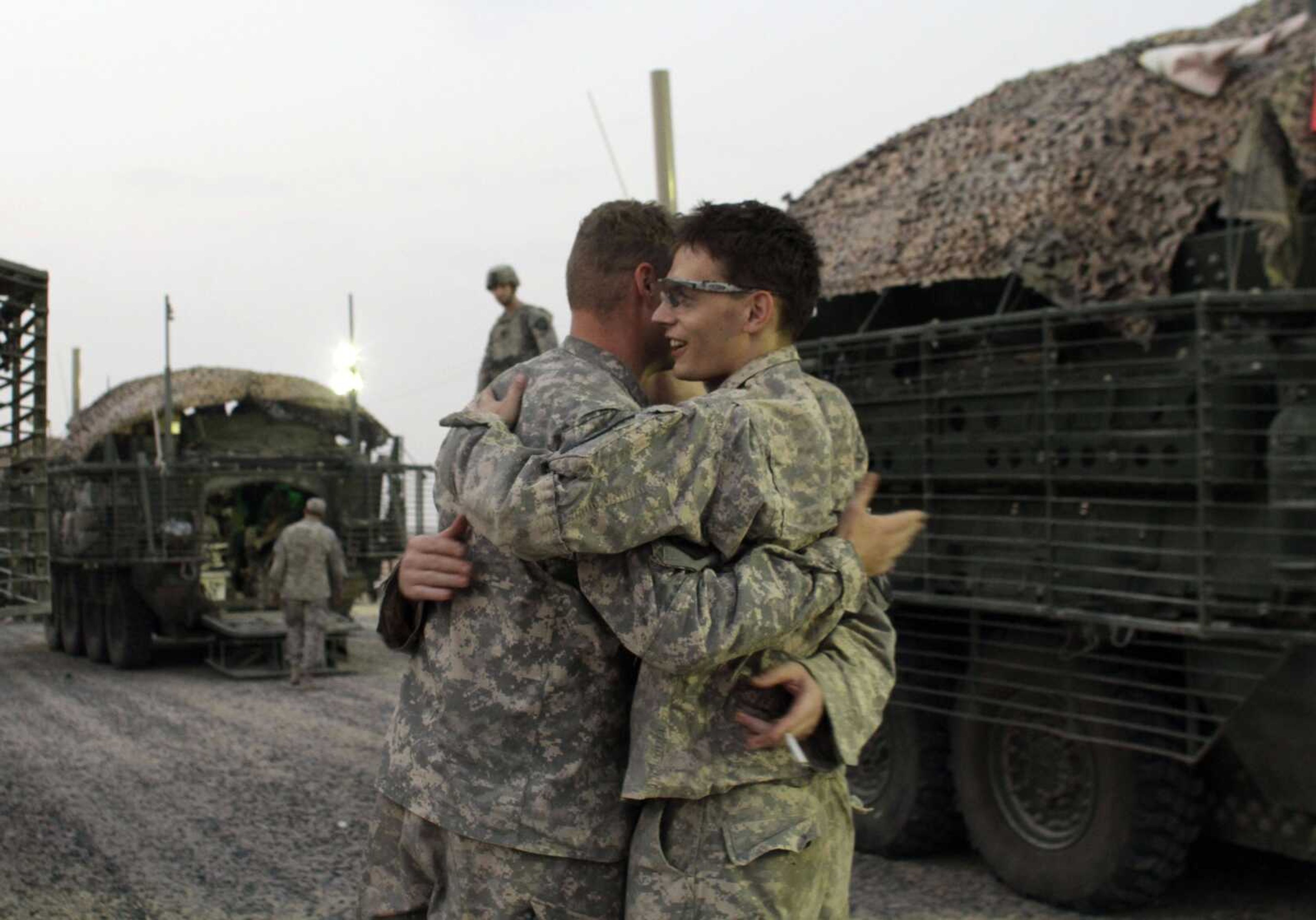 U.S. Army soldiers celebrate Monday immediately after crossing the border from Iraq into Kuwait. The U.S. Army's 4th Battalion, 9th Infantry Regiment, part of the 4th Brigade, 2nd Infantry Division, are the last combat brigade to leave Iraq as part of the drawdown of U.S. forces. (Maya Alleruzzo ~ Associated Press)