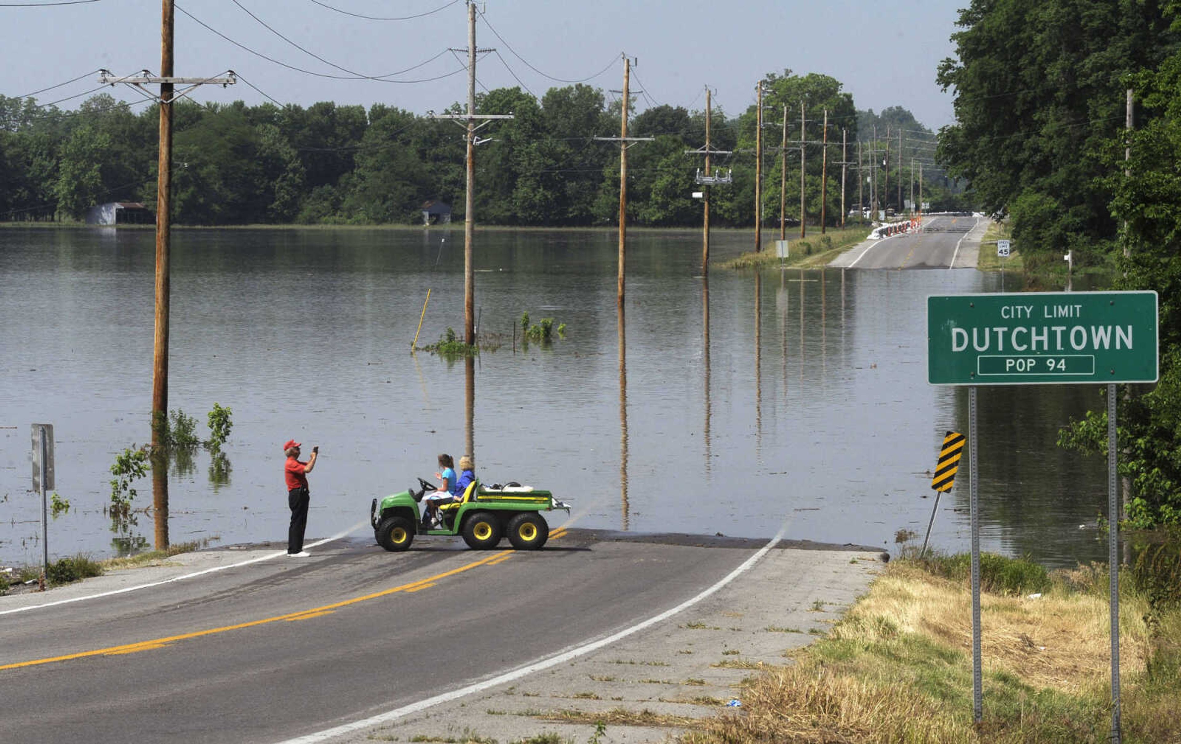 FRED LYNCH ~ flynch@semissourian.com
Cliff Overbeck takes pictures of the floodwaters over Highway 74 just east of Dutchtown on Wednesday, June 5, 2013. Highway 25 is also closed to the south of Dutchtown as well as Route A to the west.