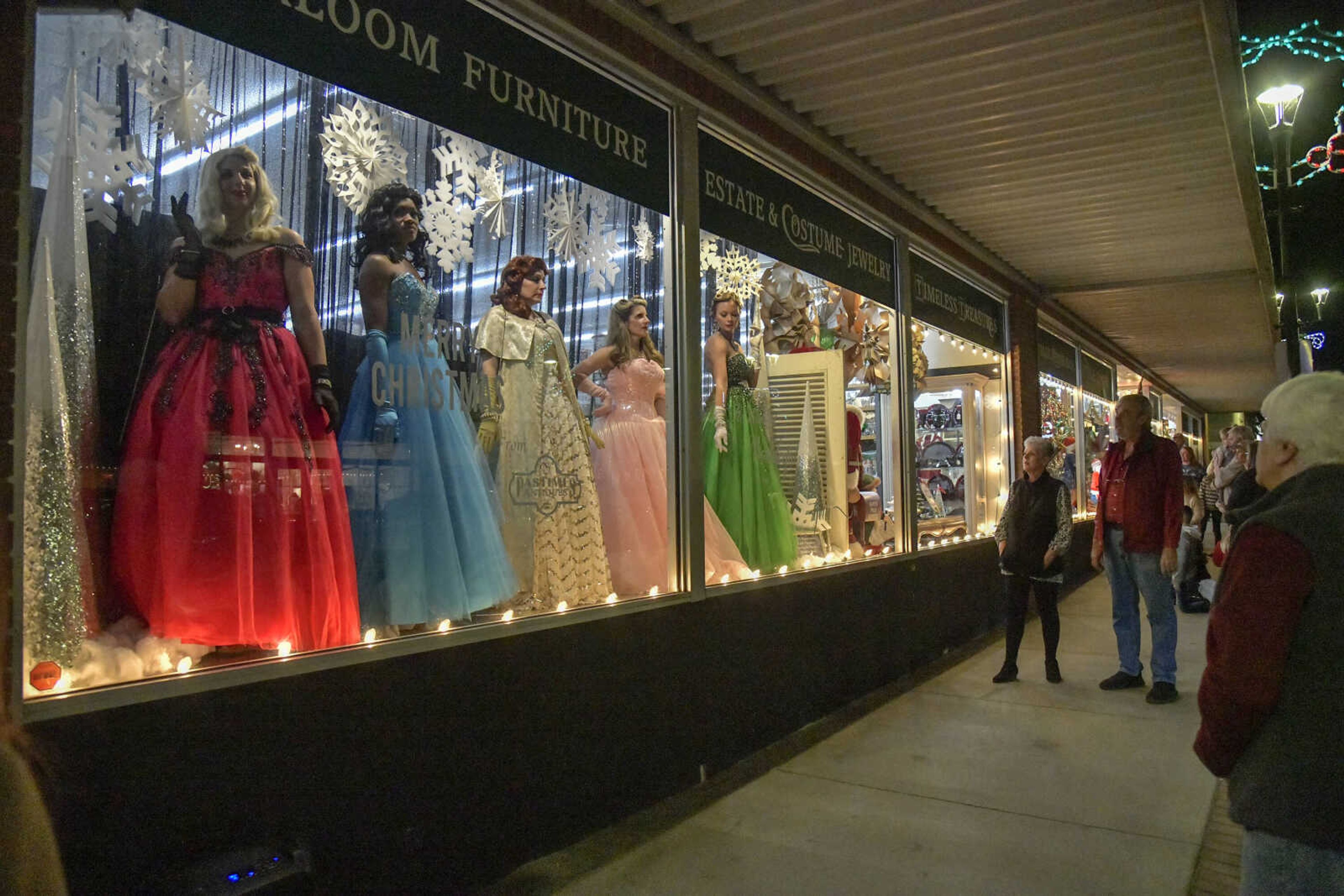 People watch "live mannequins" part of the Pastimes Antiques Christmas Window during the Annual Downtown Holiday Open House on Friday in Cape Girardeau.