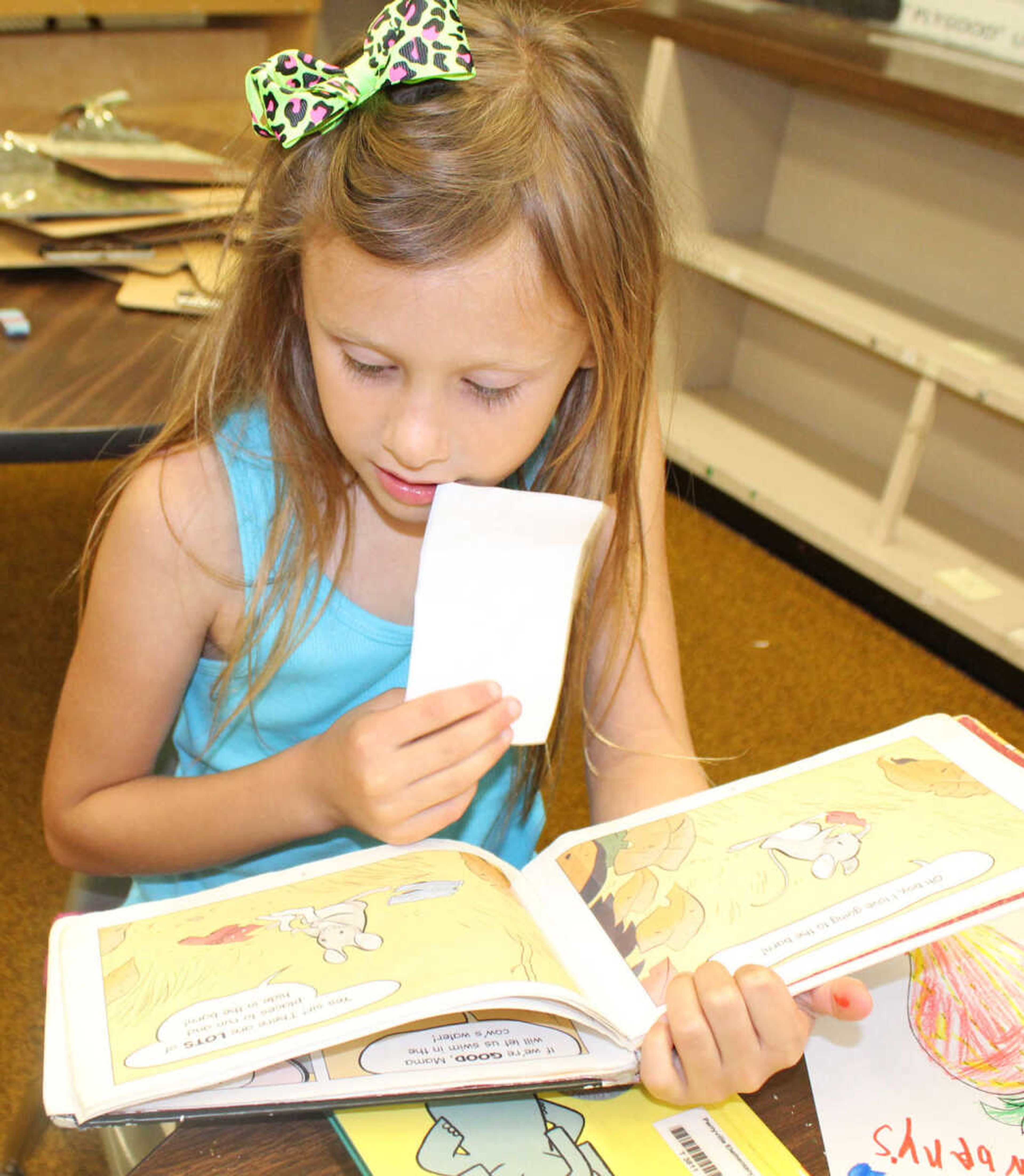 Claire Zahner reads “Little Mouse Gets Ready" at Camp Curiosity at Perryville Elementary School. All students are encouraged to participate in the Summer Reading Challenge. 