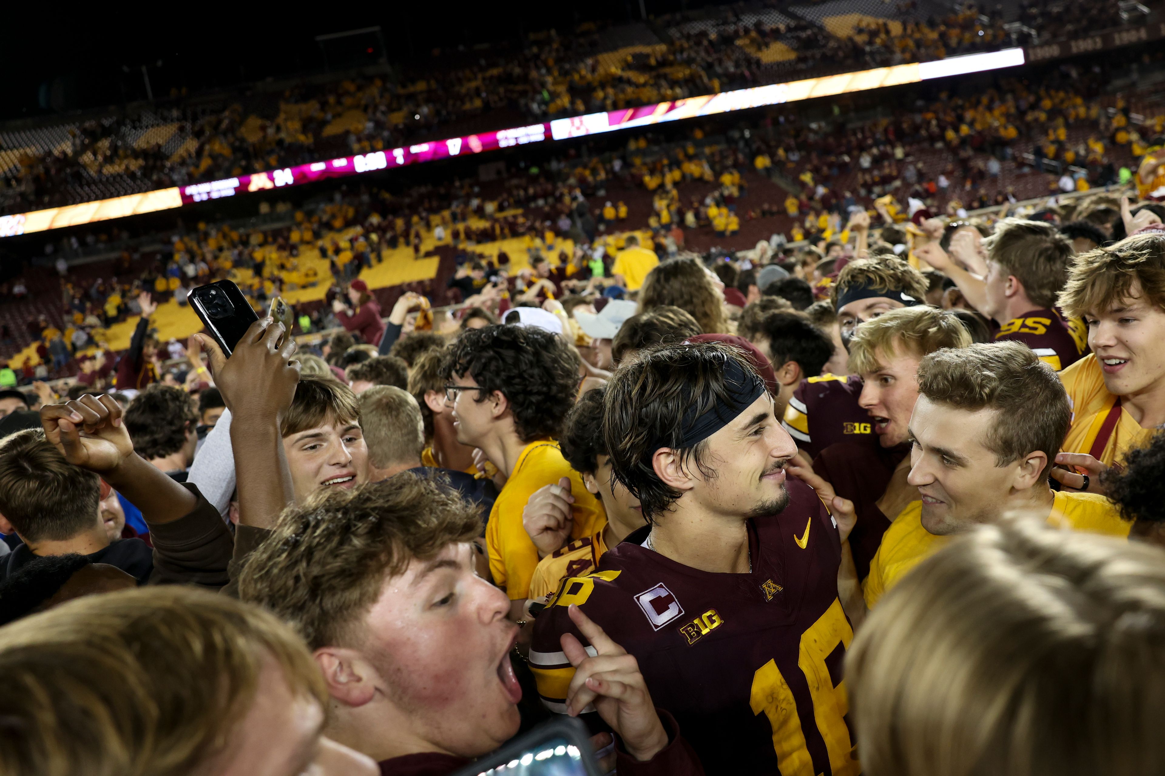 Minnesota quarterback Max Brosmer, center right, celebrates with fans after winning an NCAA college football game against Southern California Saturday, Oct. 5, 2024, in Minneapolis. (AP Photo/Ellen Schmidt)