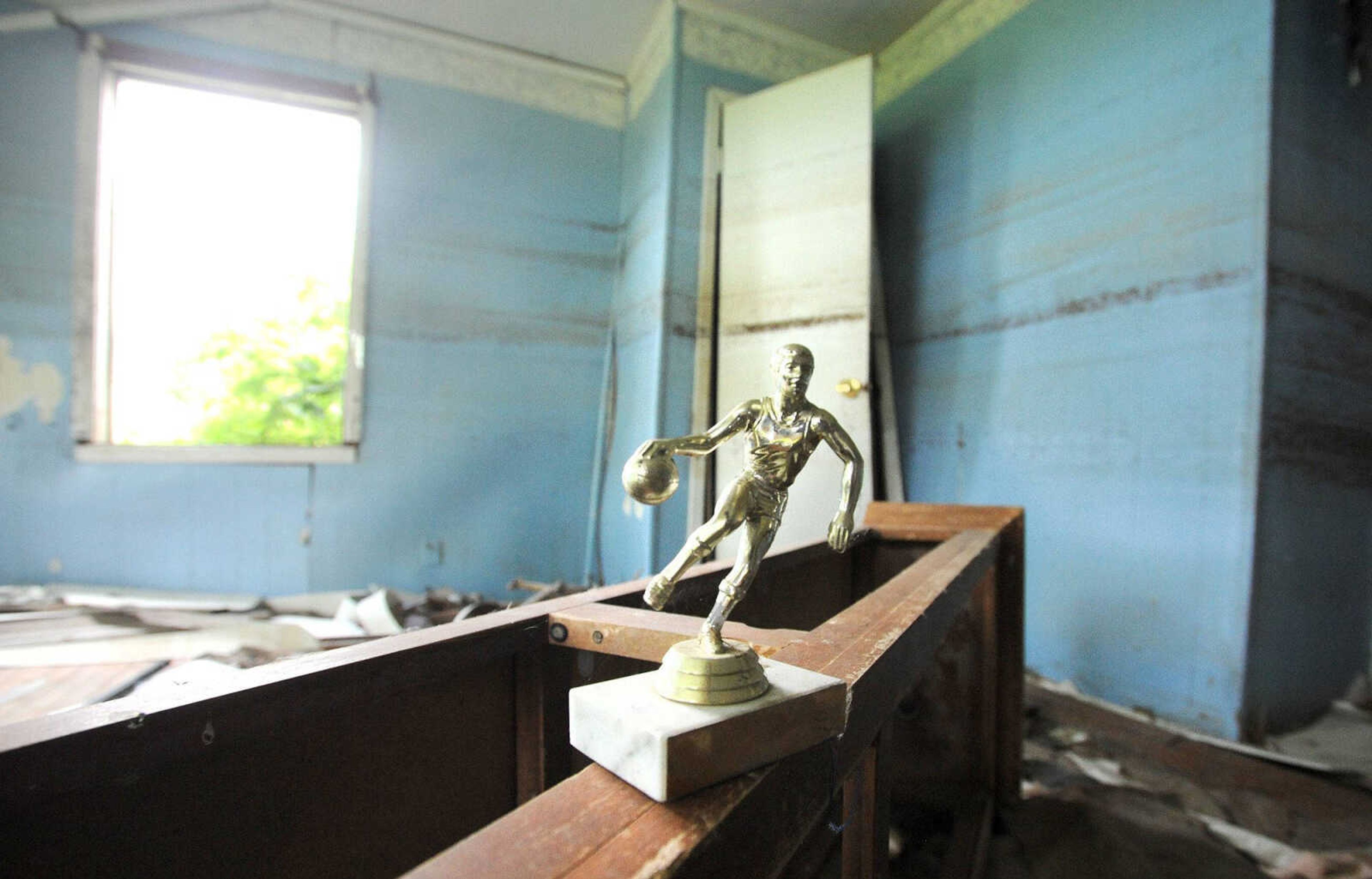 LAURA SIMON ~ lsimon@semissourian.com
A trophy sits inside a vacant Pinhook, Missouri, home Thursday. Pinhook was ravaged by floodwater in 2011 when the U.S. Army Corp of Engineers breached the Bird's Point Levee in Mississippi County, Missouri, to help relieve the swollen Mississippi River.  Demolition of the remaining structures in Pinhook began Thursday. (Laura Simon)