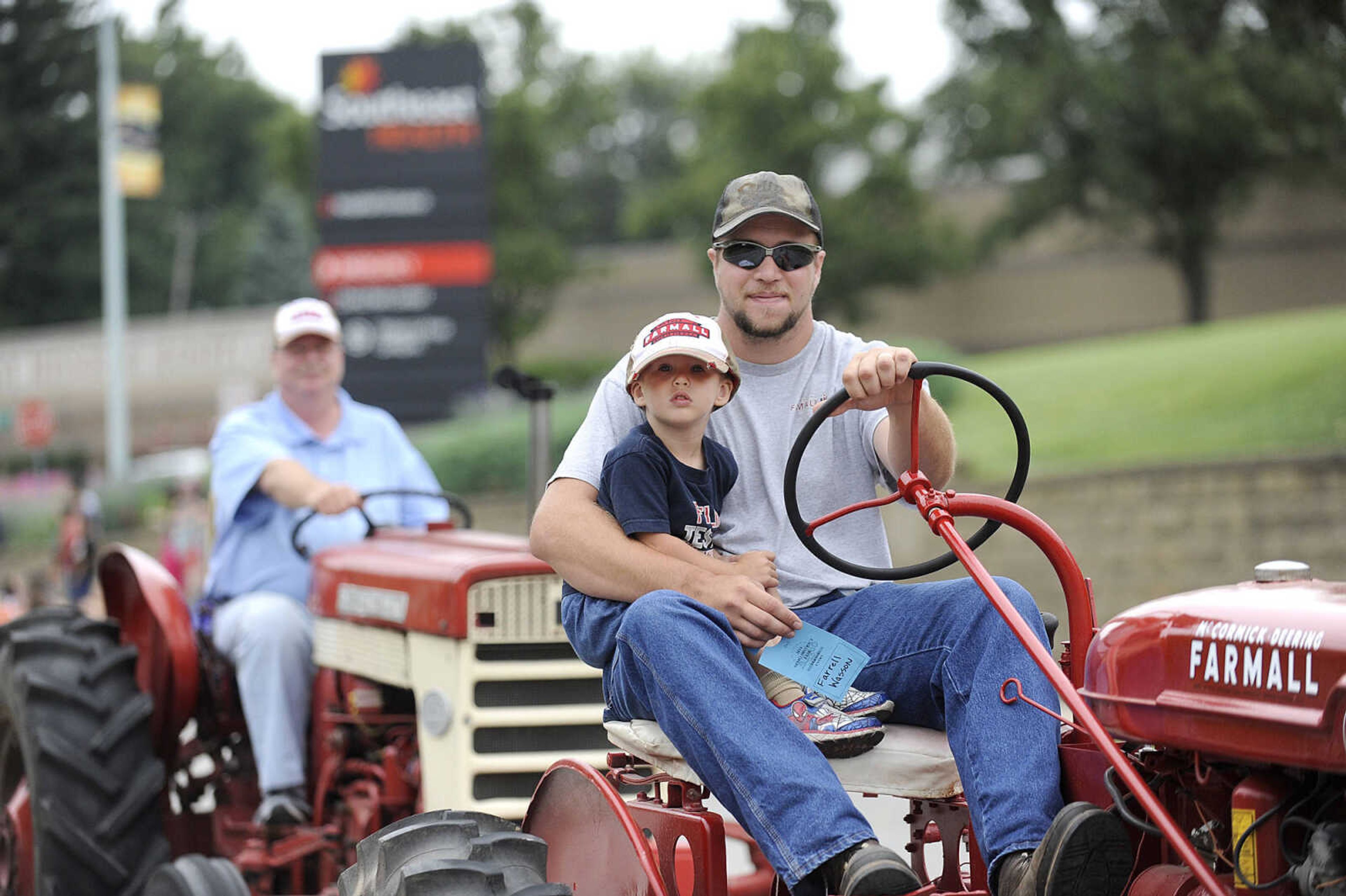 GLENN LANDBERG ~ glandberg@semissourian.com

Farrell Wasson and his son Drew drive down Broadway as part of the SEMO District Fair Parade on a 1946 Farmall B Saturday morning, Sept. 6, 2014. The parade ended at Arena Park where the 159th annual SEMO District Fair is being held.