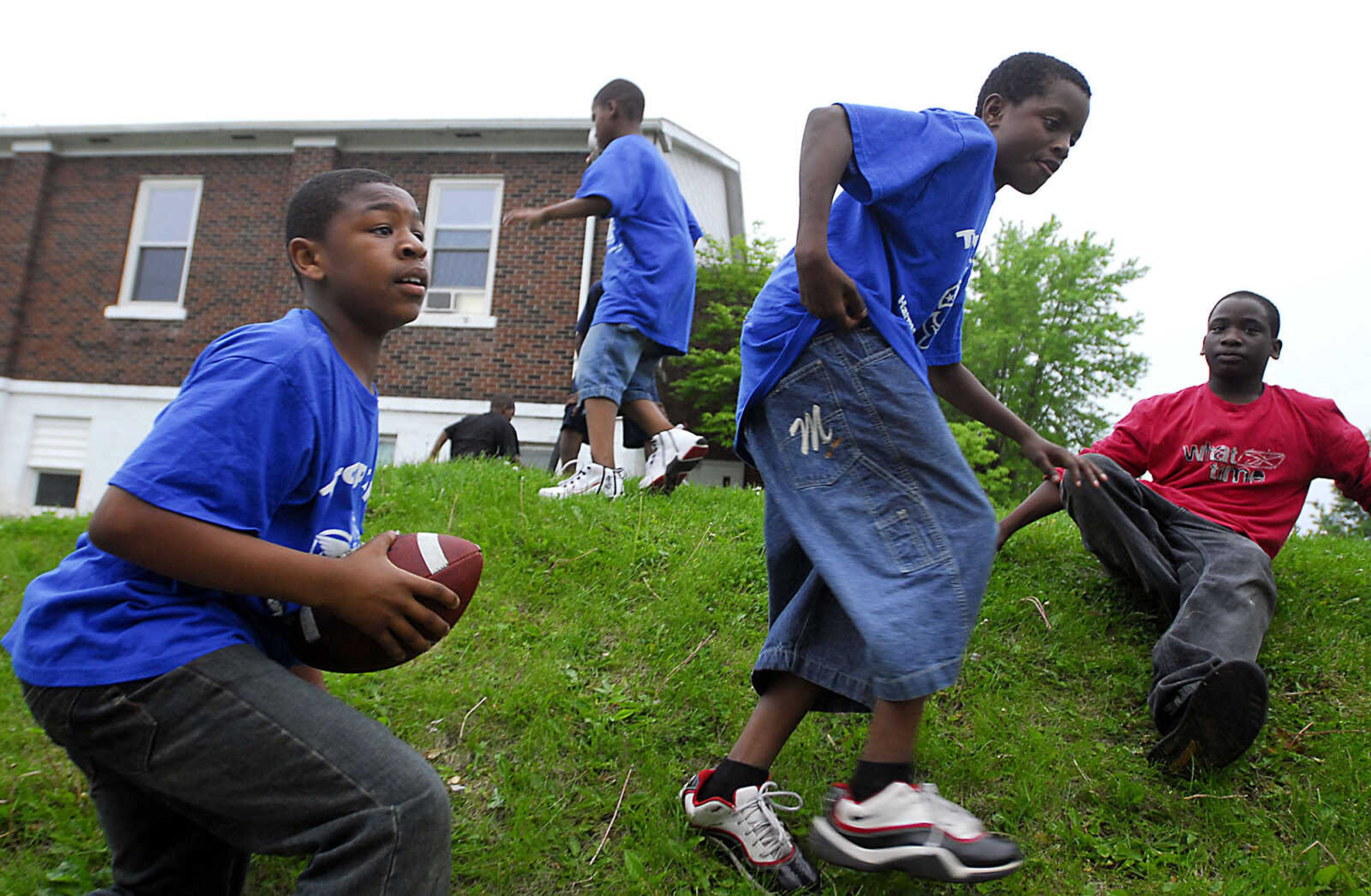 Brent Battles, 11, left, grabs the football while playing with Troop 215 before a scout meeting Tuesday, May 5, 2009, at Cape Area Family Resource Center.