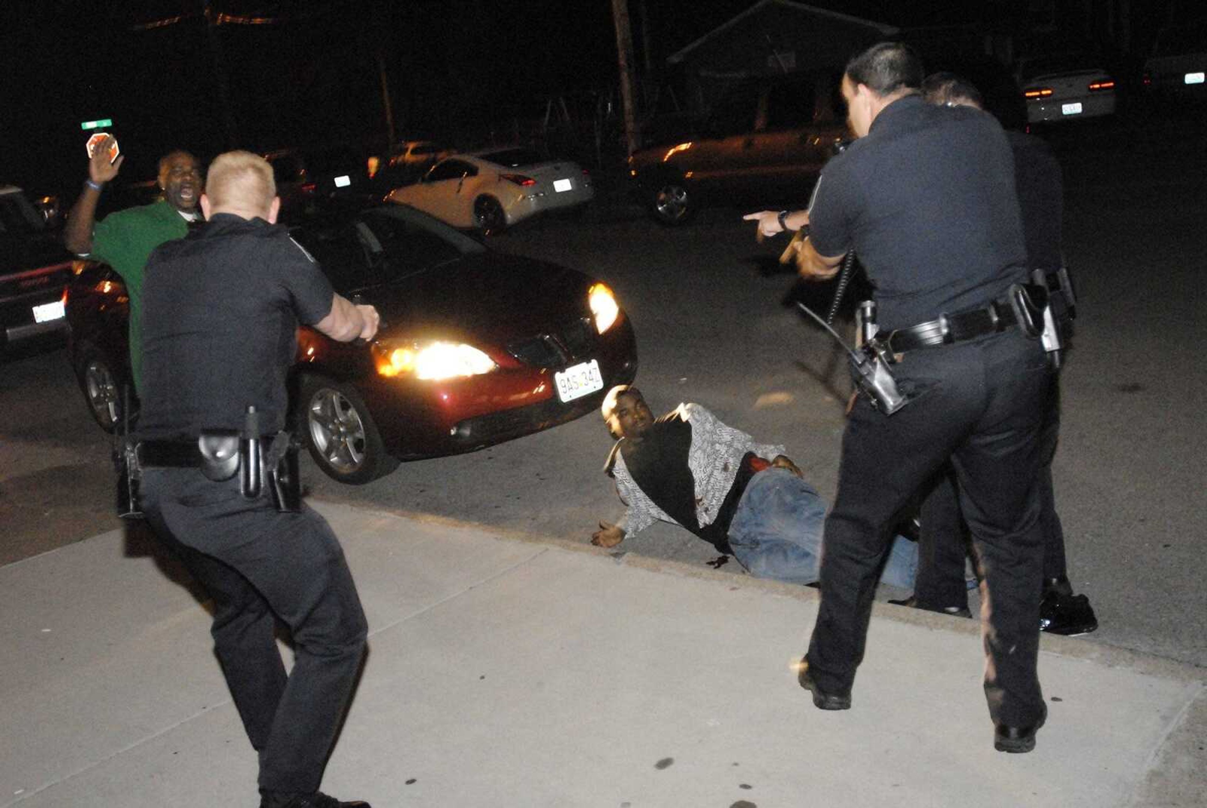 Cape Girardeau police officers surround Jordan T. Modicue, 20, of Tamms, Ill., who was shot four times early Sunday morning, Sept. 28, 2008, as police responded to reports of a fight outside the Copa, a North Main Street bar. (Missourian photo by Chuck Wu)