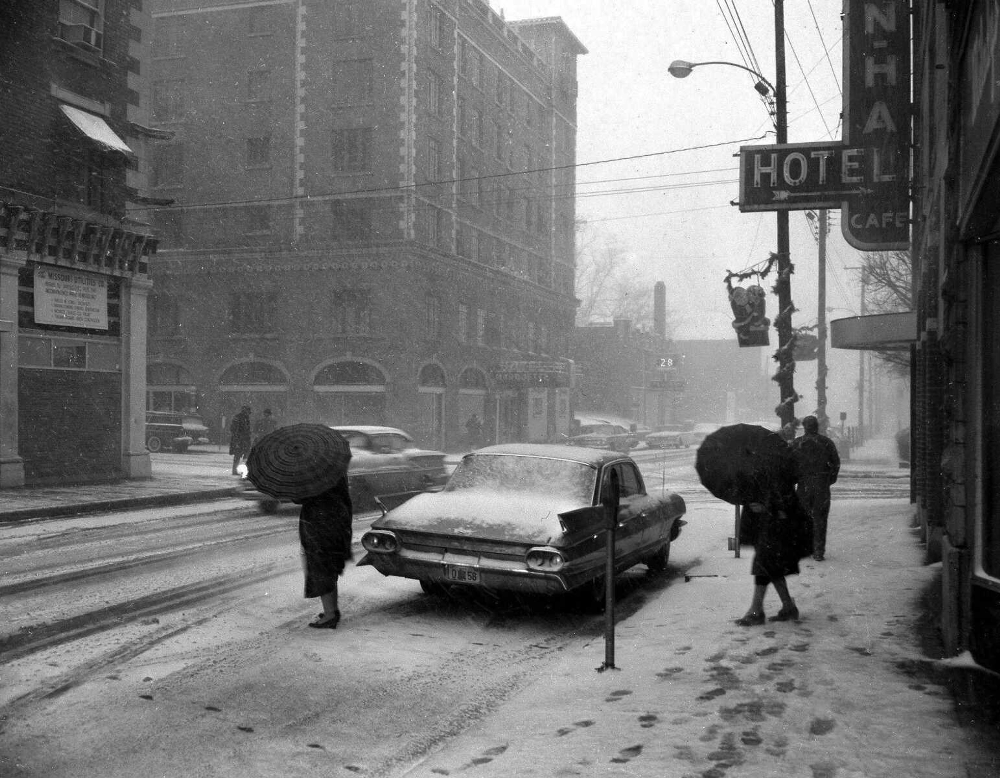 Published Dec. 21, 1960.
Winter arriving some 24 hours ahead of time really blew up a storm as this picture at Broadway and Fountain well illustrates. It was a blizzard of proportions seldom seen in these parts that brought 3 inches of snow and traffic snarls of record size. And, the calendar says Winter actually didn't arrive until this afternoon. (G.D. Fronabarger ~ Southeast Missourian archive)