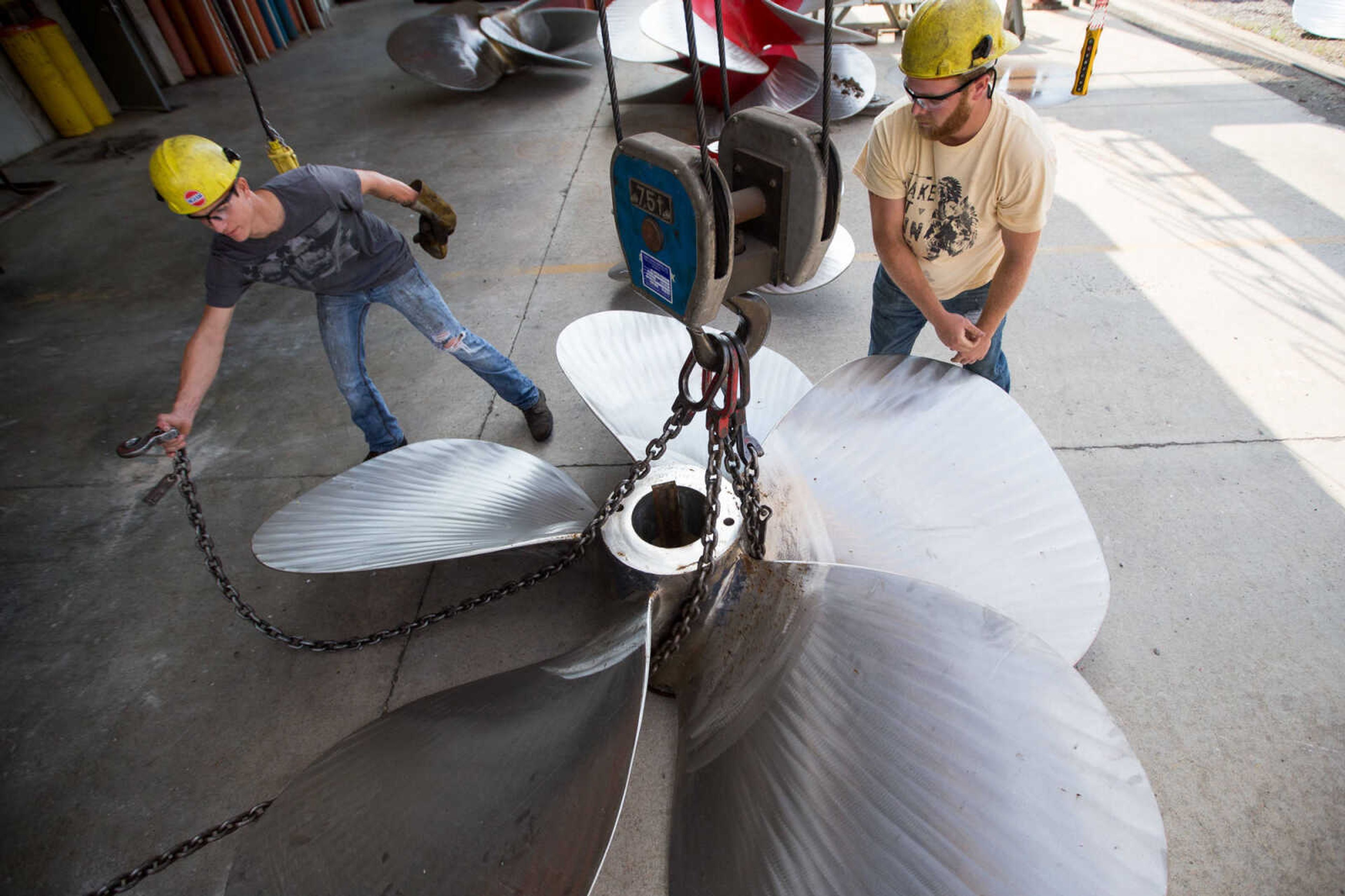 GLENN LANDBERG ~ glandberg@semissourian.com

Kyler Hale and Logan Farrenburg hook chains to a propeller that will be moved by a crane outside the repair shop at Missouri Dry Dock and Repair Co. in Cape Girardeau Wednesday, July 28, 2016.