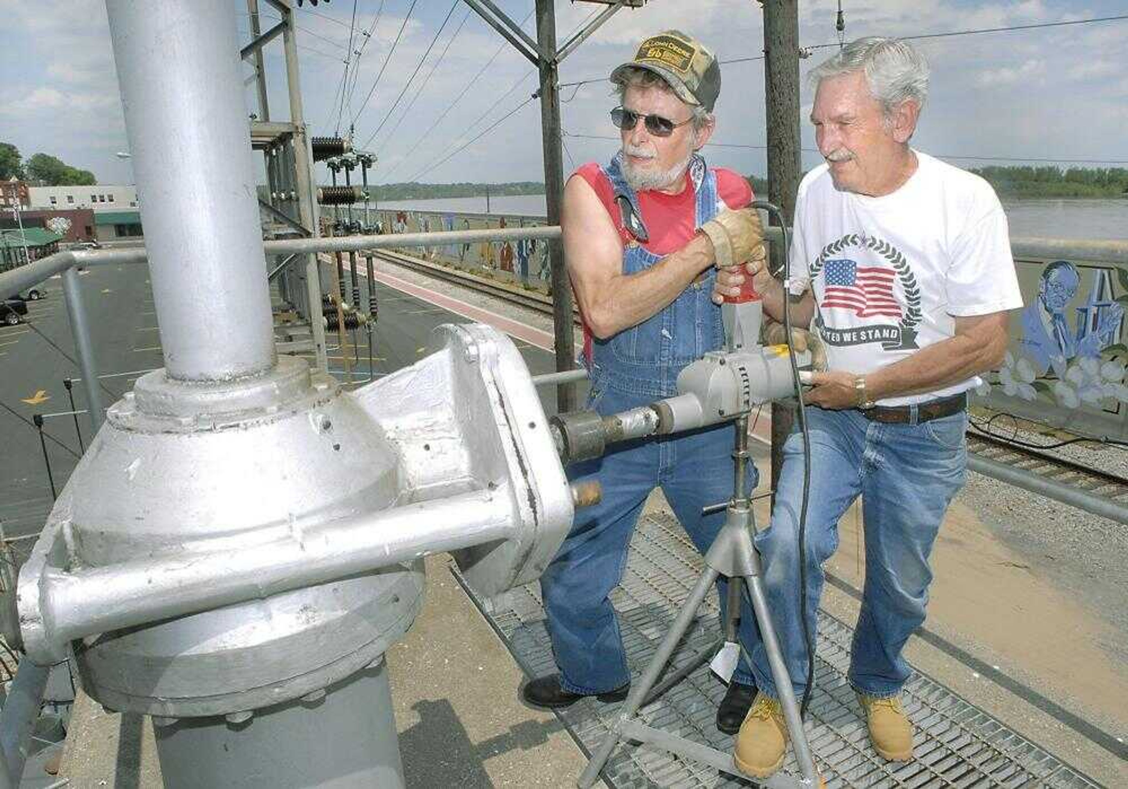 Howard Thomas, left, and Gordon Morgan operated a gear mechanism atop the Merriwether Street pumping station that would close the gate to the 7-foot storm drain tunnel leading to the Mississippi River on Thursday afternoon. (Fred Lynch)