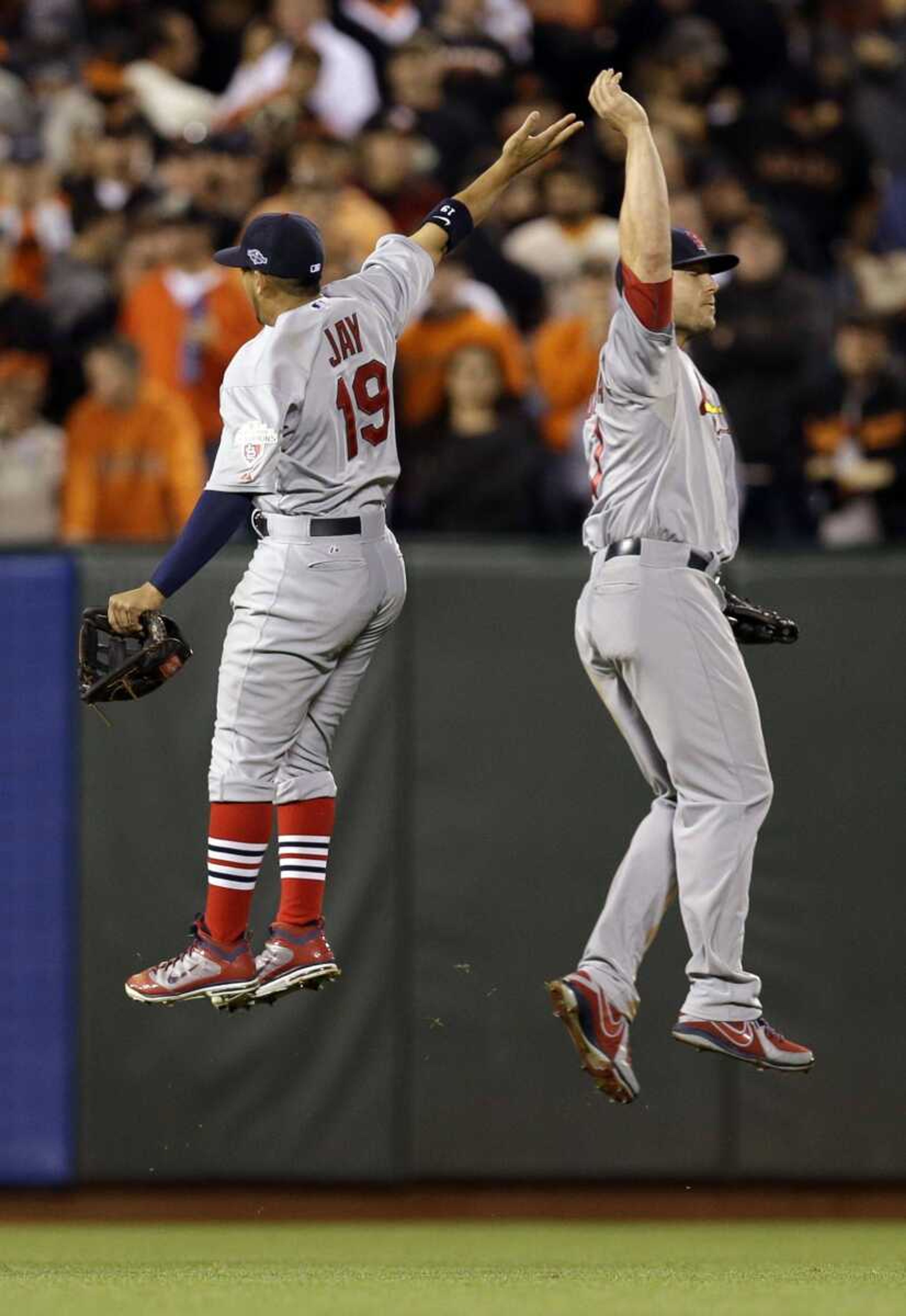 Cardinals outfielders Jon Jay and Matt Holliday celebrate after a 6-4 victory over the Giants in Game 1 of the National League championship series Sunday in San Francisco. (David J. Phillip ~ Associated Press)