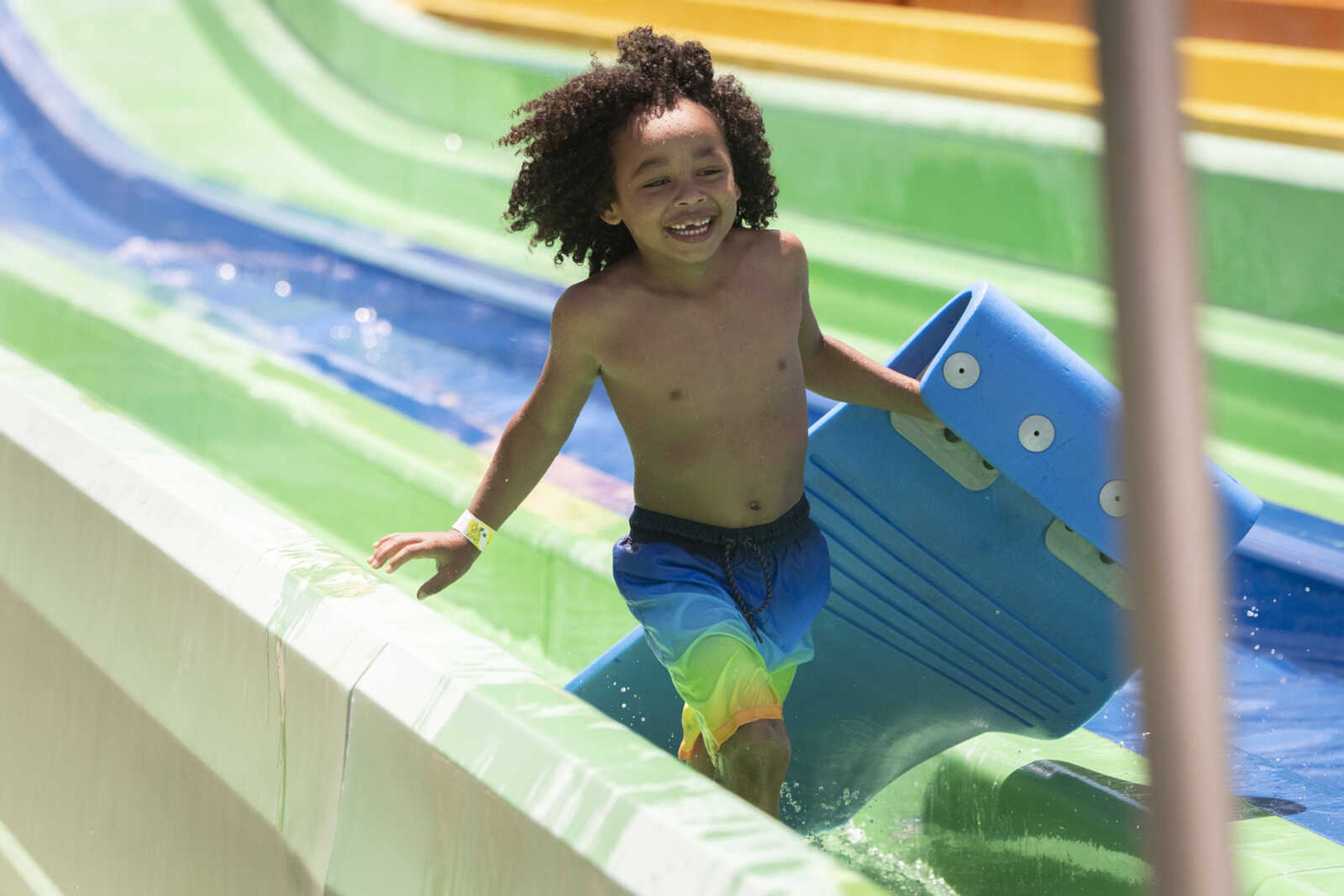 Zaking Poyner, 5, of Sikeston, Missouri, gets off a water slide Wednesday, June 10, 2020, at Cape Splash Family Aquatic Center in Cape Girardeau.