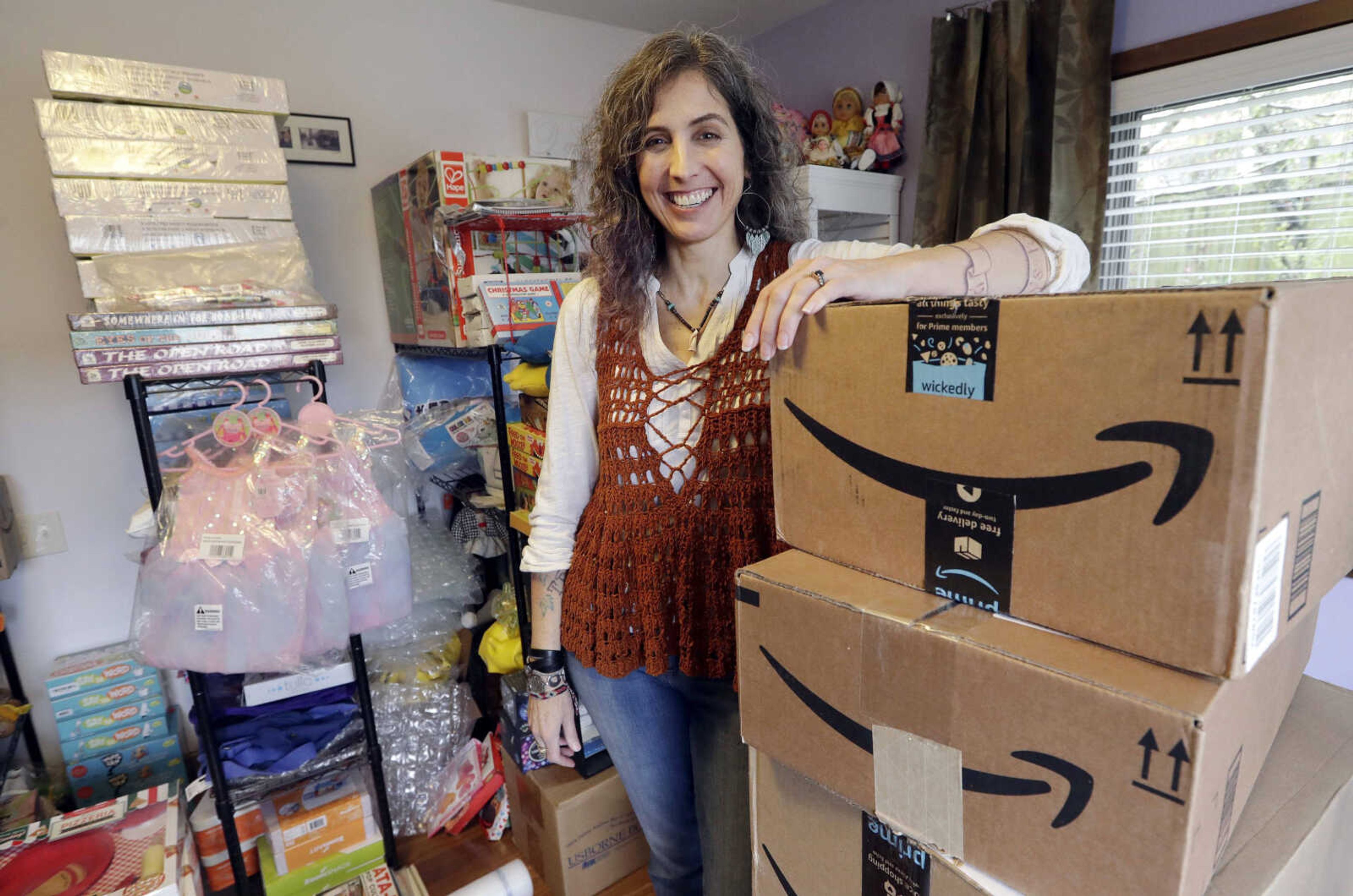 Adrienne Kosewicz, owner of Play It Safe World Toys, poses for a portrait April 6 in her home office in Seattle. Kosewicz pays $3,300 a year for tax collection software to handle payments and reports to her home state, Washington. Her Seattle-based online business sells through Amazon, which handles computation and collection.