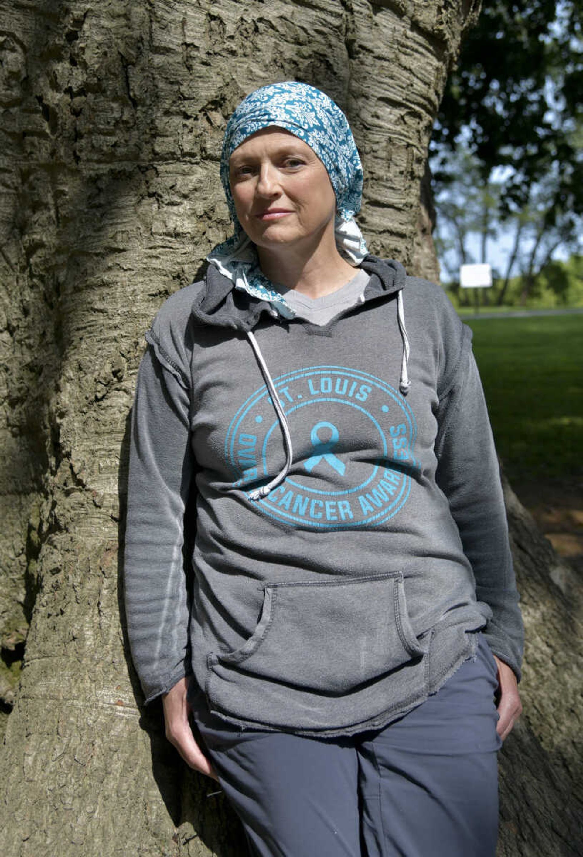 Sandi Essner leans against one of the largest and oldest American beech trees in Missouri at River Campus Park on Sept. 18. "We are both trying to stay alive," Essner said in reference to herself and the tree.