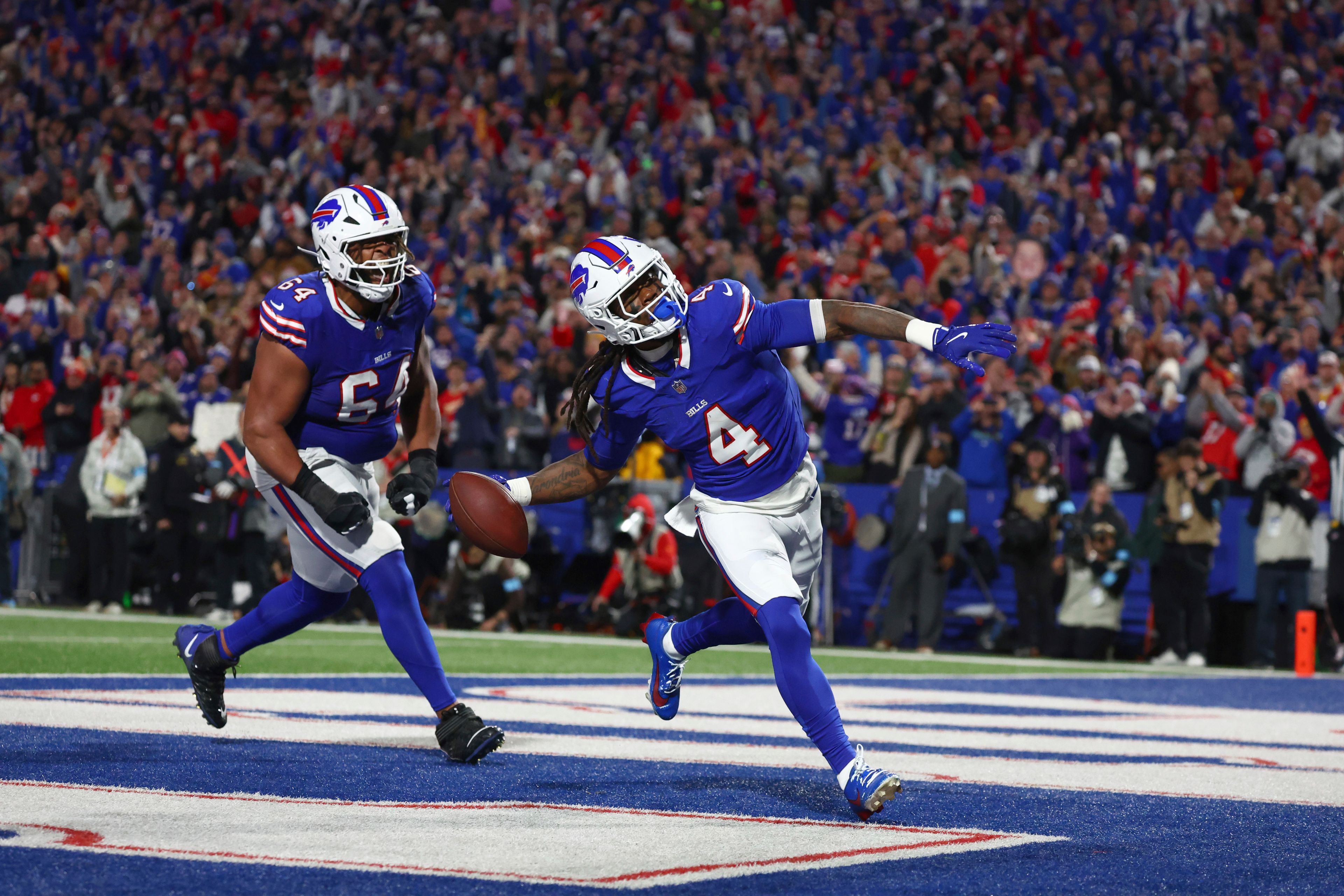 Buffalo Bills running back James Cook (4) celebrates after scoring on a 6-yard run as teammate O'Cyrus Torrence (64) watches during the first half of an NFL football game against the Kansas City Chiefs Sunday, Nov. 17, 2024, in Orchard Park, N.Y. (AP Photo/Jeffrey T. Barnes)