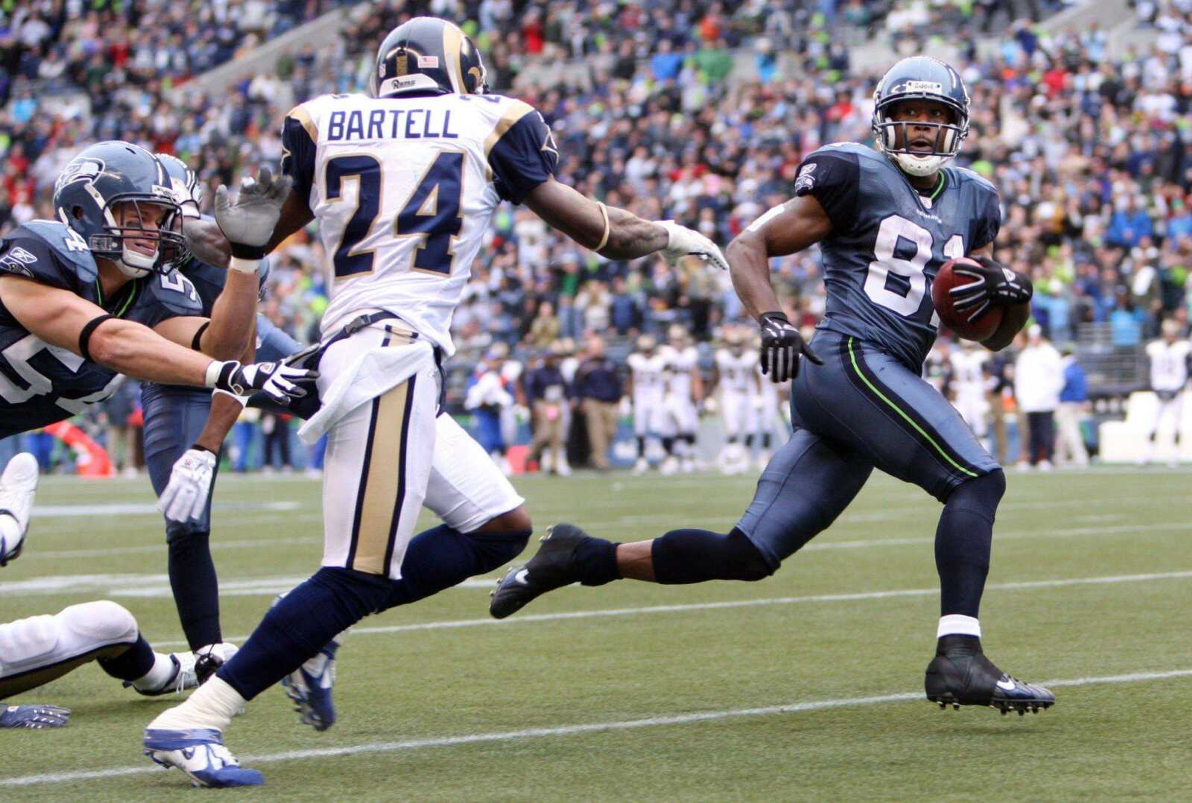 The Seahawks' Nate Burleson ran past the Rams' Ron Bartell on his way to a 91-yard touchdown on the opening kickoff of the second half Sunday in Seattle. (ROD MAR ~ Associated Press)