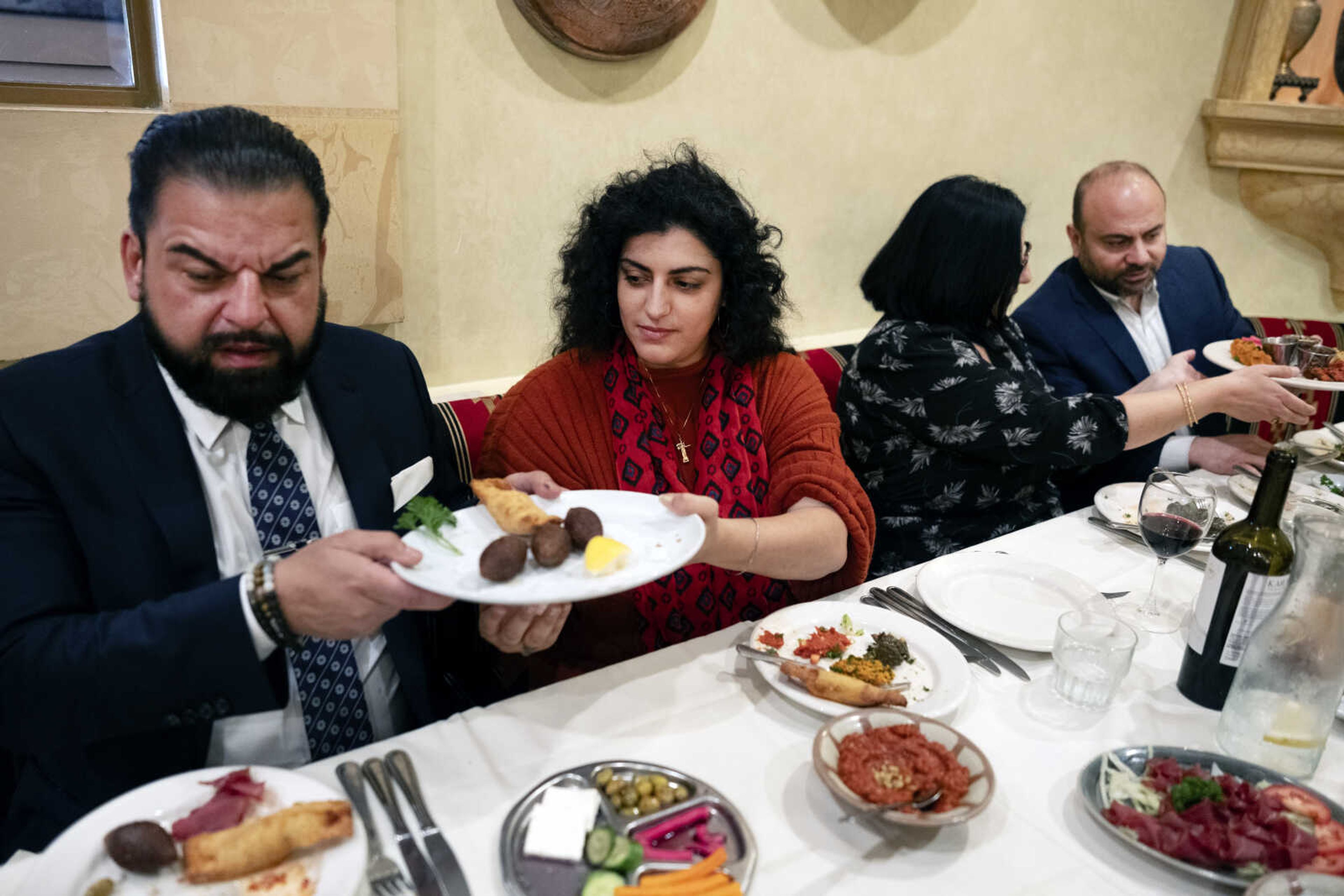 Sophia Armen, center, passes a dish to Dr. Armond Aghakhanian and joined for lunch with other members of the Armenian-American Census Coalition, Suzie Abajian and former California Assembly Member Adrian Nazarian at the Carousel, a Lebanese-Armenian restaurant, May 17 in Glendale, California. For some race and ethnic groups, how the U.S. government categorizes them for crucial surveys and the once-a-decade census is still falling short. Hmong as well as Armenian, Arab American and Brazilian communities say they feel excluded or diminished when it comes to how they are counted in their own country.