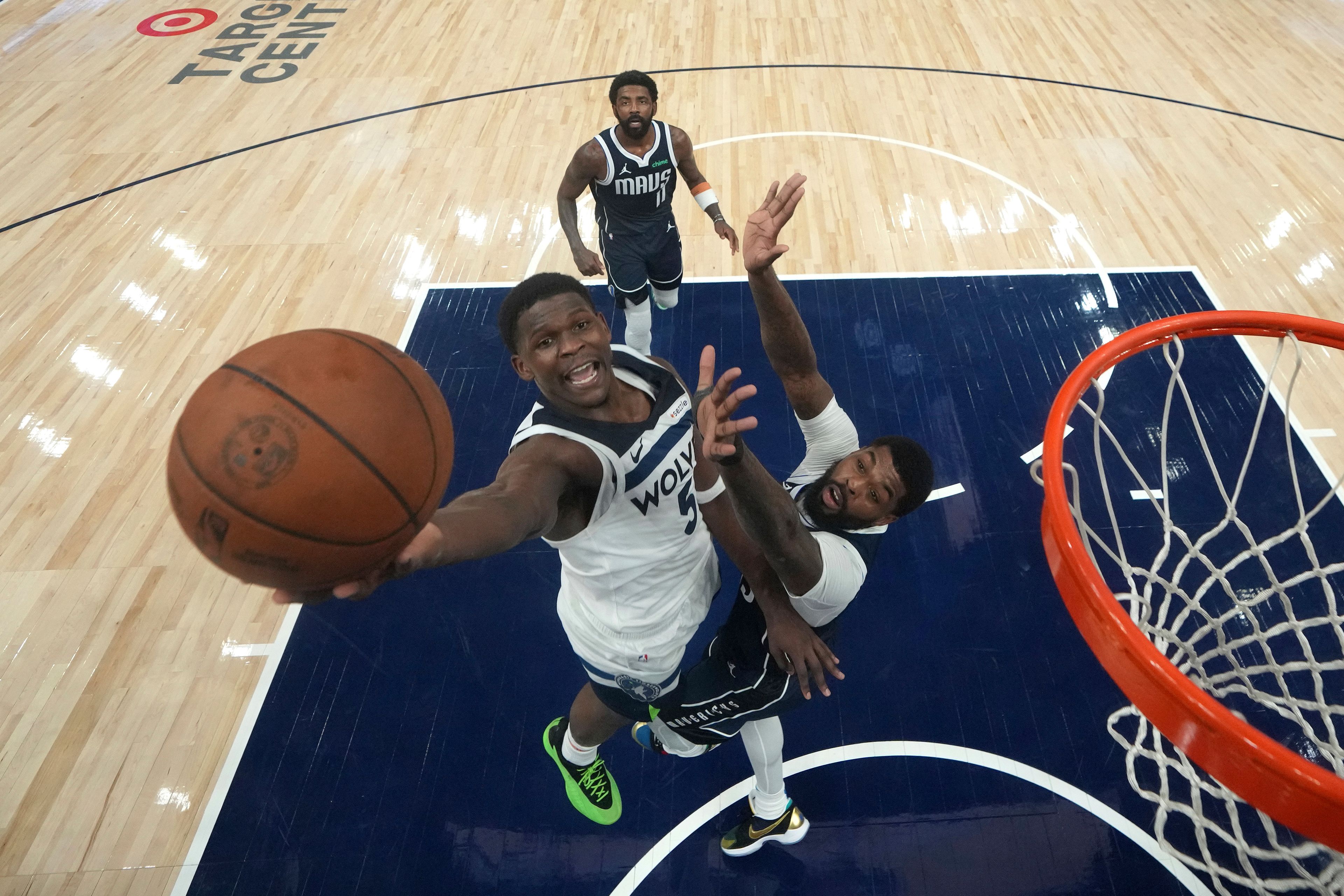 Minnesota Timberwolves guard Anthony Edwards, left, goes up for a shot as Dallas Mavericks forward Naji Marshall defends during the second half of an NBA basketball game, Tuesday, Oct. 29, 2024, in Minneapolis. (AP Photo/Abbie Parr)