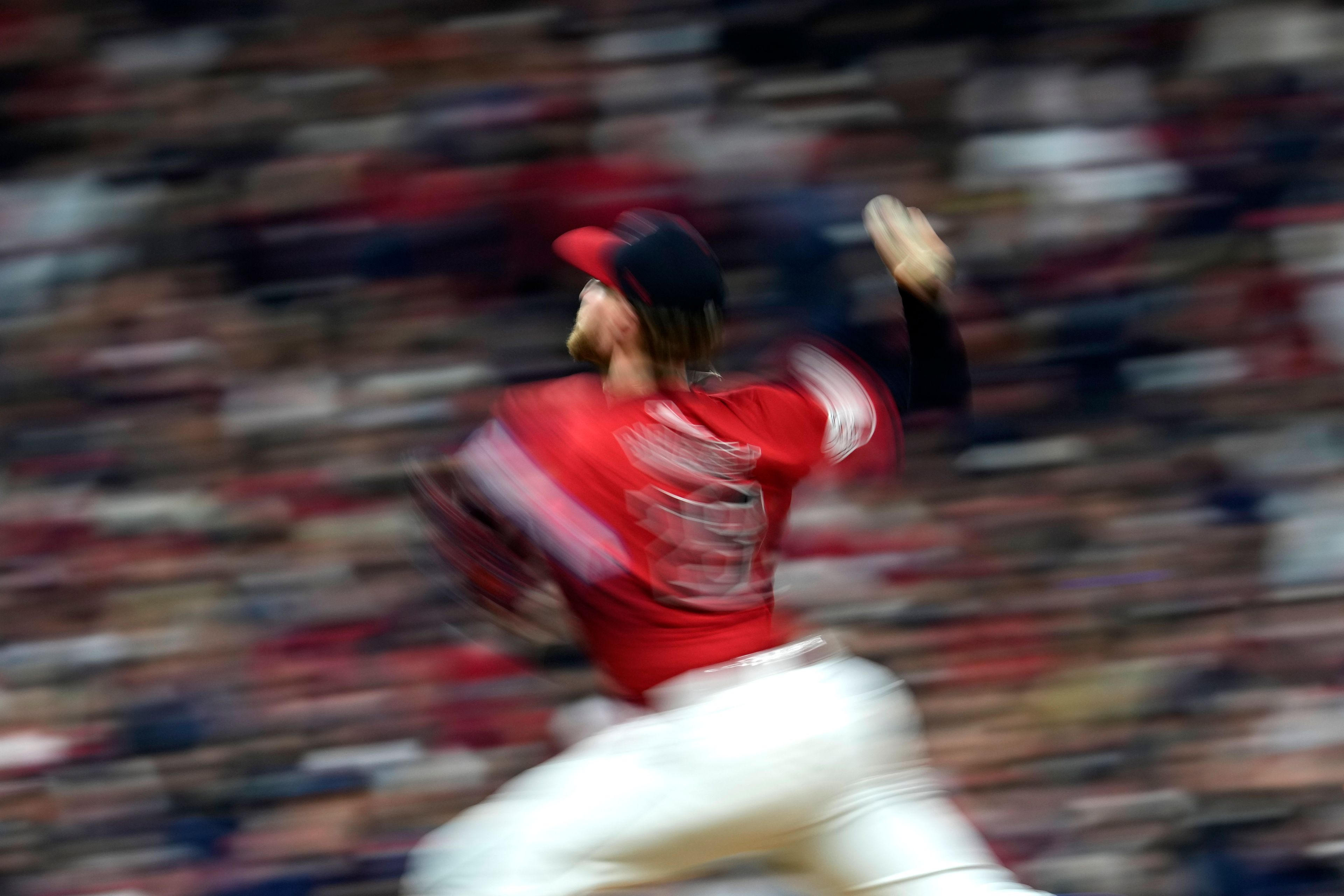 In this image taken with a slow shutter speed, Cleveland Guardians starting pitcher Tanner Bibee throws against the New York Yankees during the fourth inning in Game 5 of the baseball AL Championship Series Saturday, Oct. 19, 2024, in Cleveland. (AP Photo/Godofredo A. Vásquez)