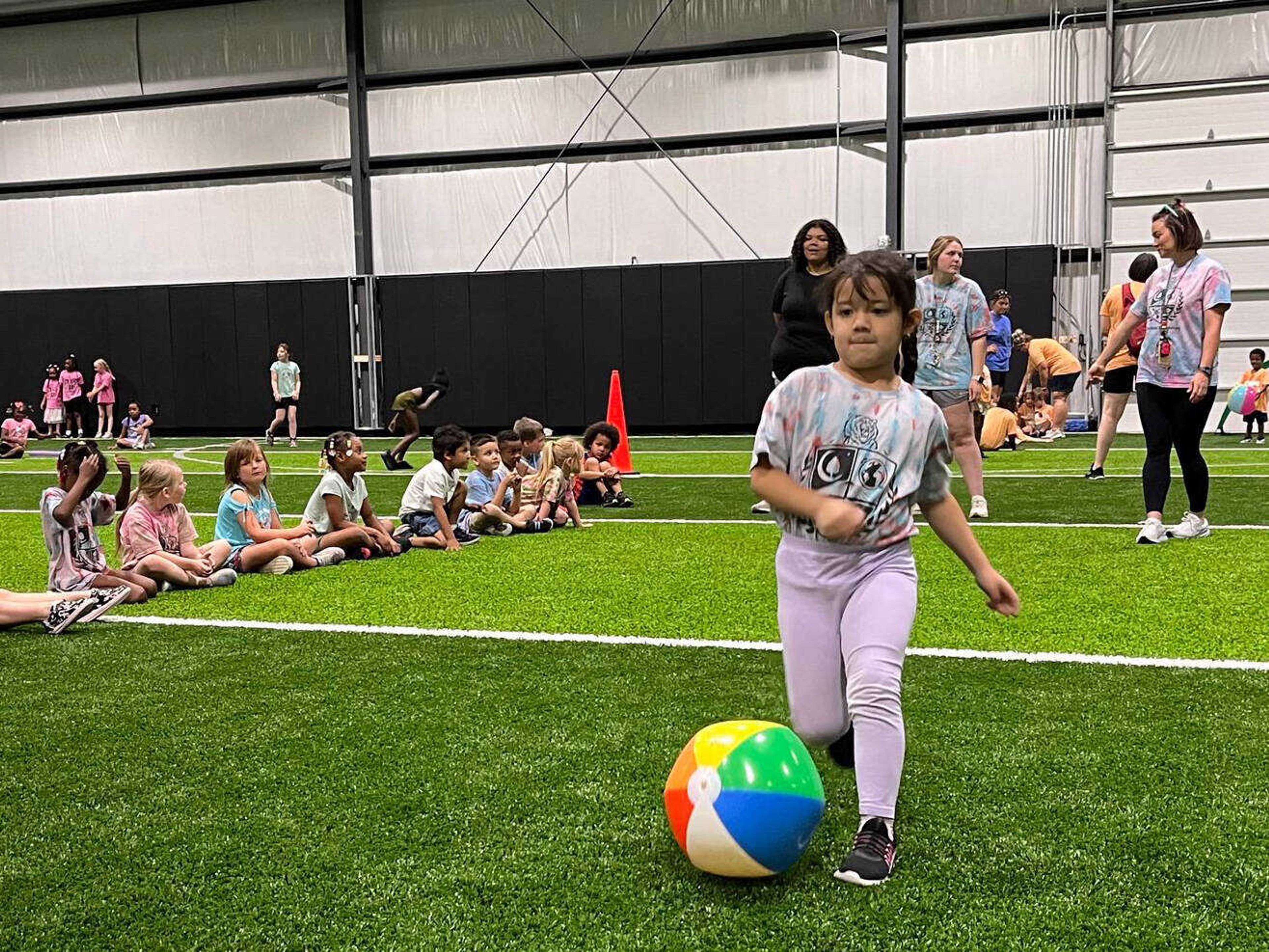 An elementary student participates in beach ball soccer during the final day of summer school Friday, June 7, at Cape Central High School in Cape Girardeau.