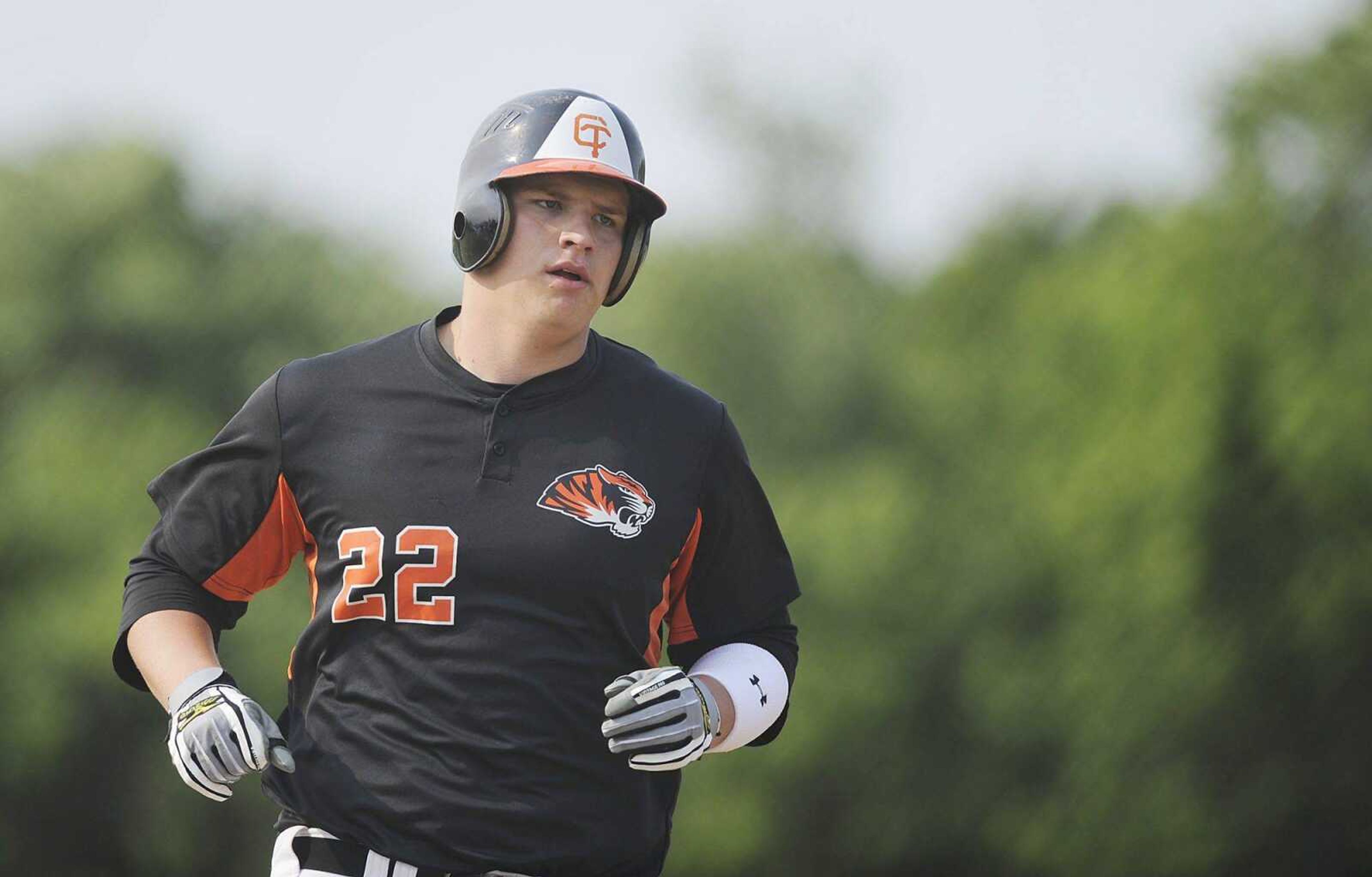 LEFT: Central first baseman Ramsey Scott circles the bases after hitting a two-run home run during the first inning of the Tigers&#8217; Class 4 quarterfinal game against Rockwood Summit. RIGHT: Central pitcher Ethan Dambach throws during the first inning.