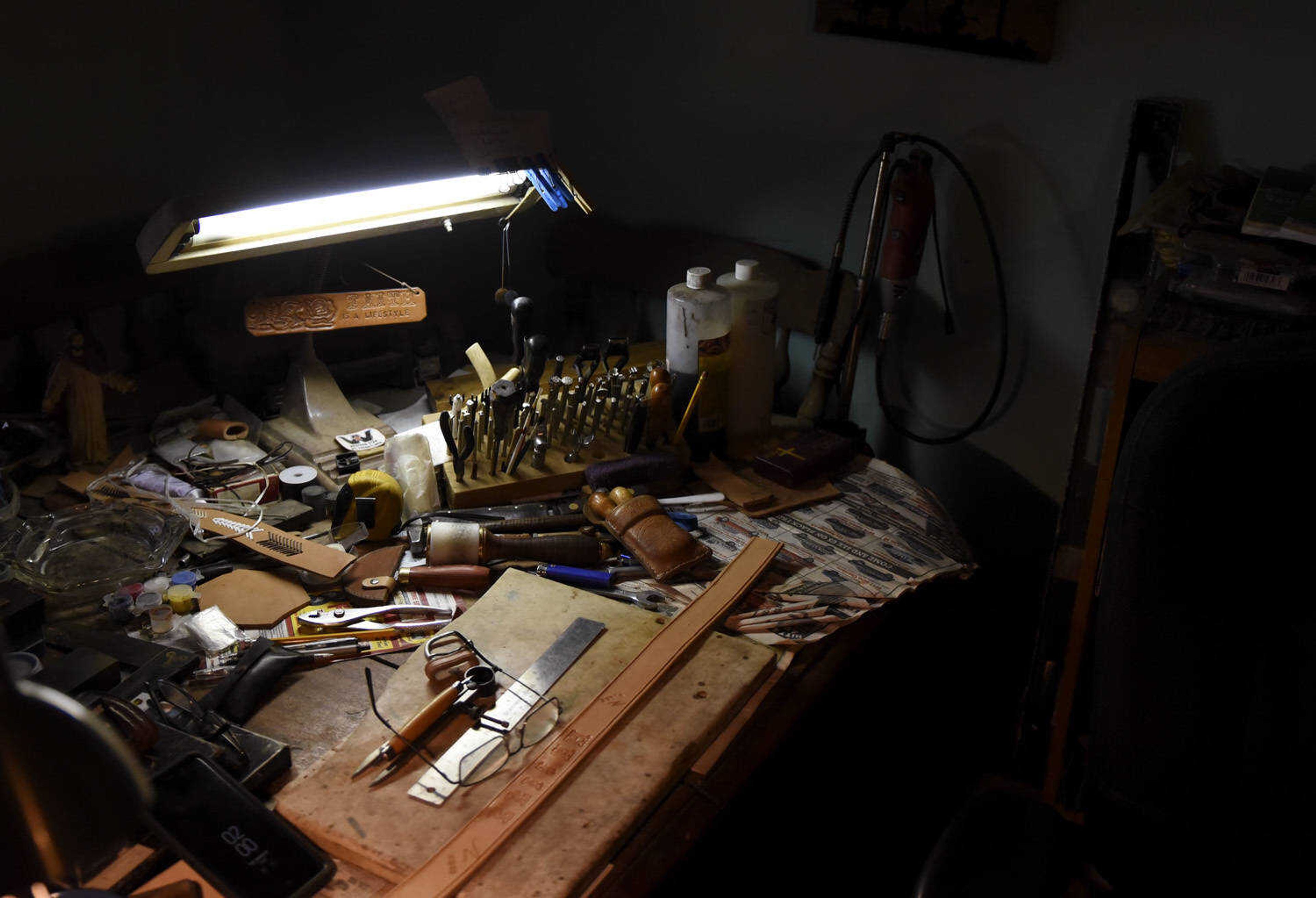 Leather-making tools lie on John Hedge's desk in his home on Tuesday, March 27, 2018, in Advance.