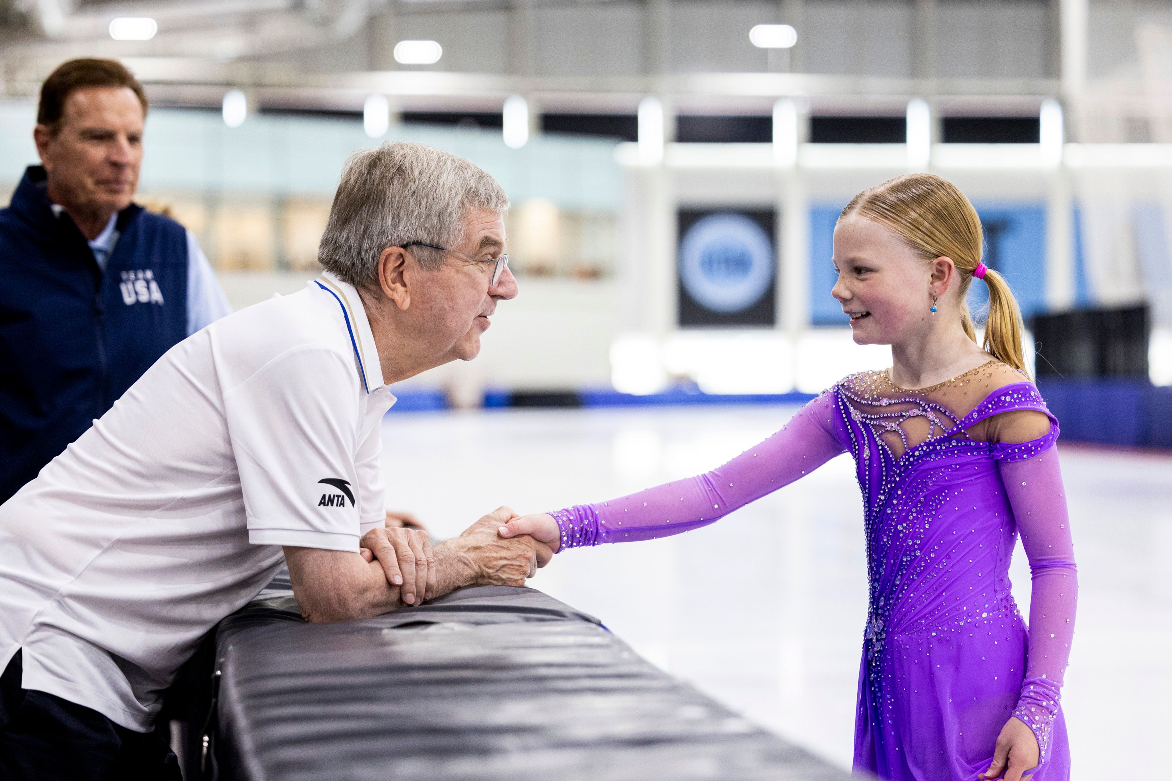 International Olympic Committee President Thomas Bach shakes hands with figure skater Annabelle Atkinson, 10, of Salt Lake City, as they talk at the Utah Olympic Oval in Kearns, Utah, Saturday, Sept. 28. 2024. (Isaac Hale/The Deseret News via AP)