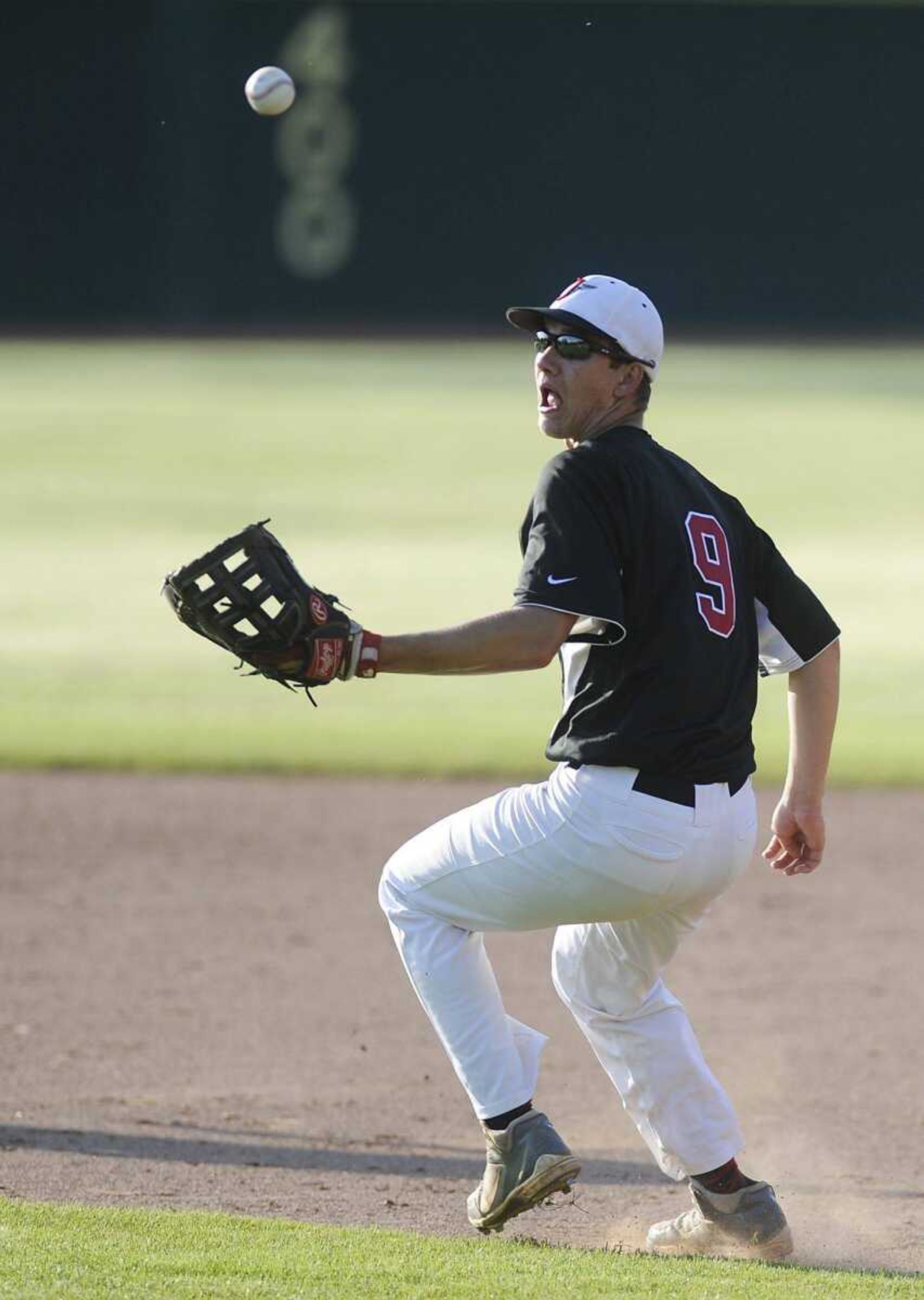 Jackson's Kyle James tries to get a handle on a ground ball during the Indians' win over Sikeston.