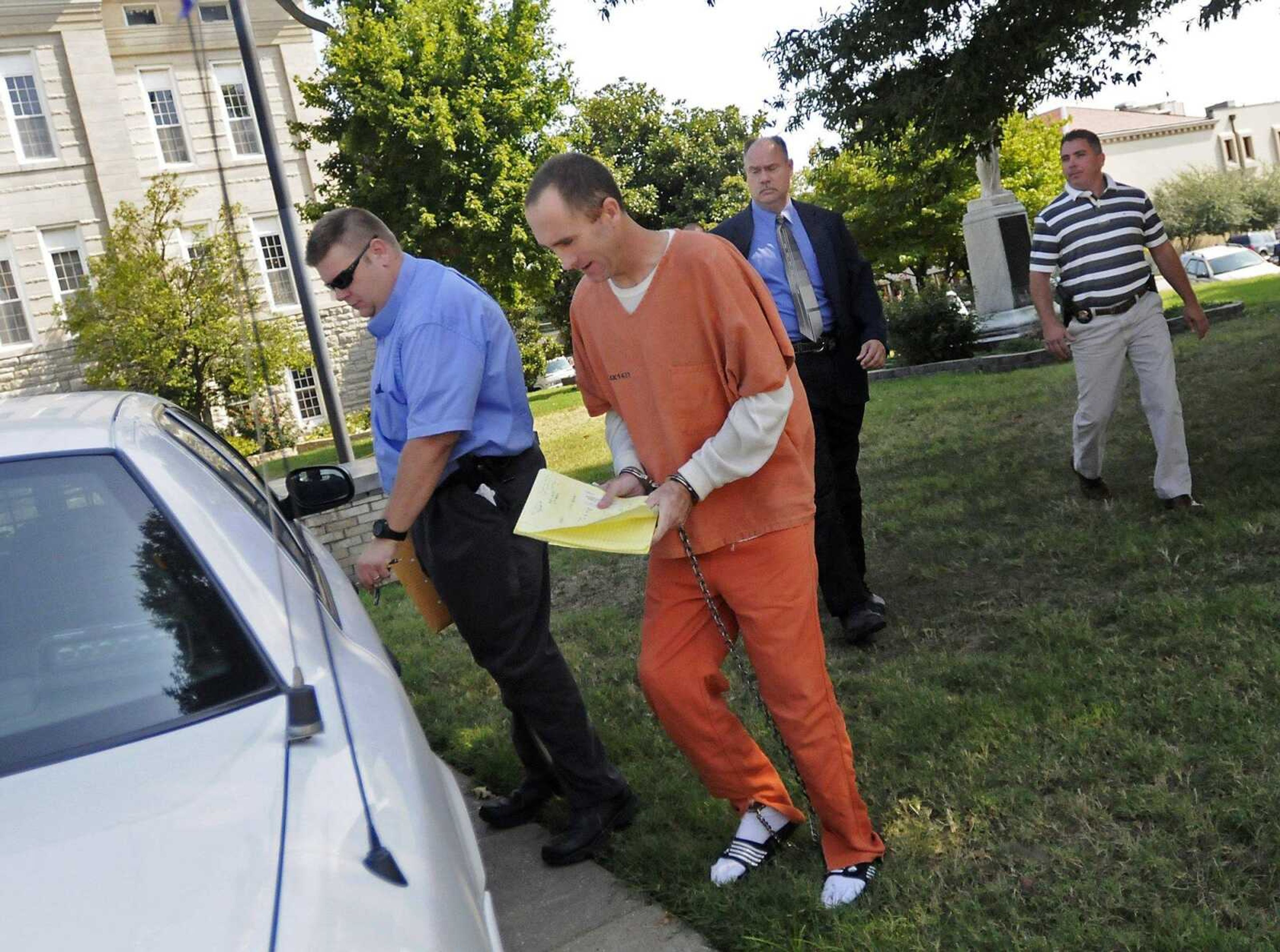 In this file photo Clay Waller, center, is escorted to a police vehicle after a court hearing at the Cape Girardeau County Courthouse in Jackson on Tuesday, Aug. 23, 2011, where he appeared on charges of stealing and harassment. (Kristin Eberts)