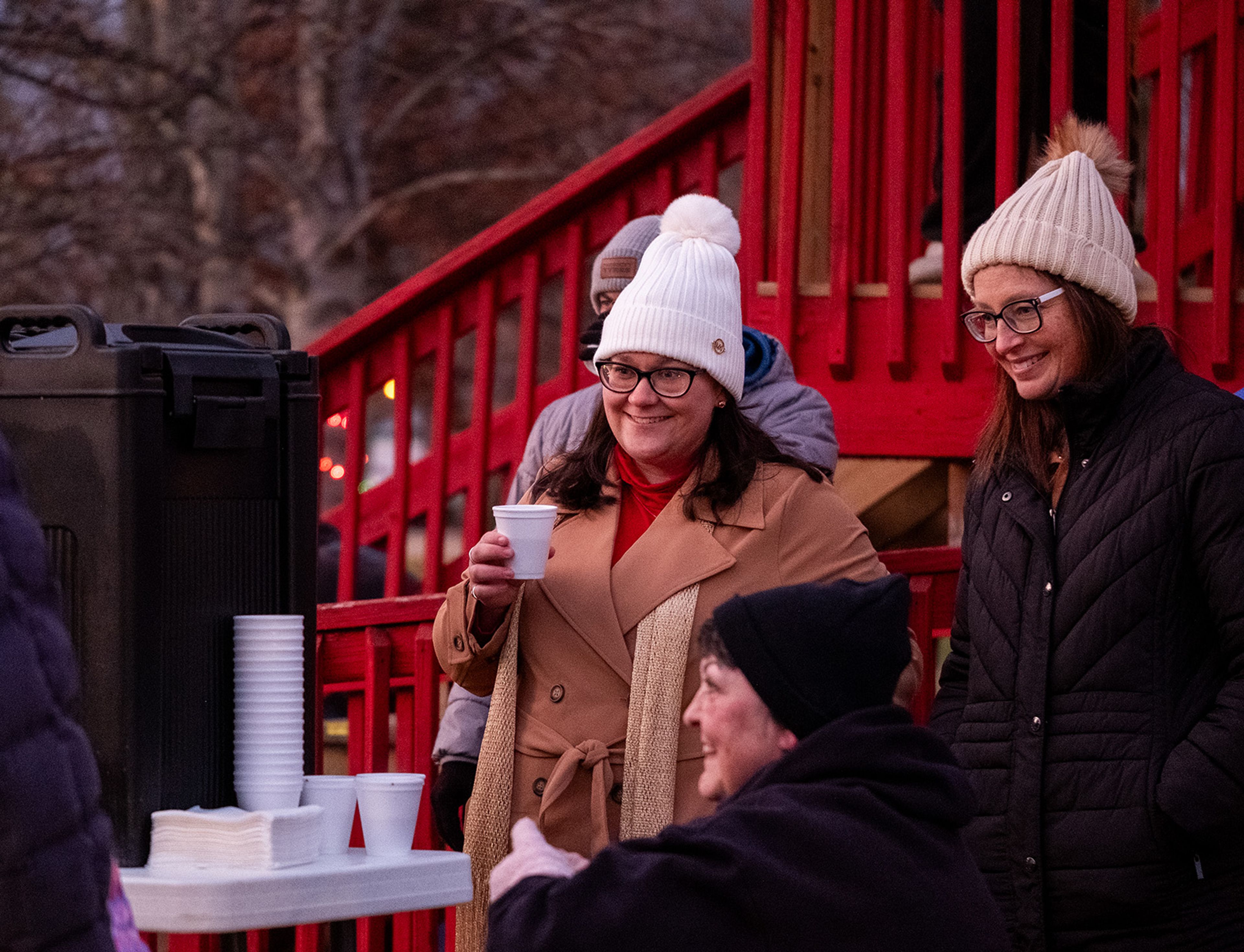 Visitors share laughter and hot cocoa as they await the lighting of the tree.
