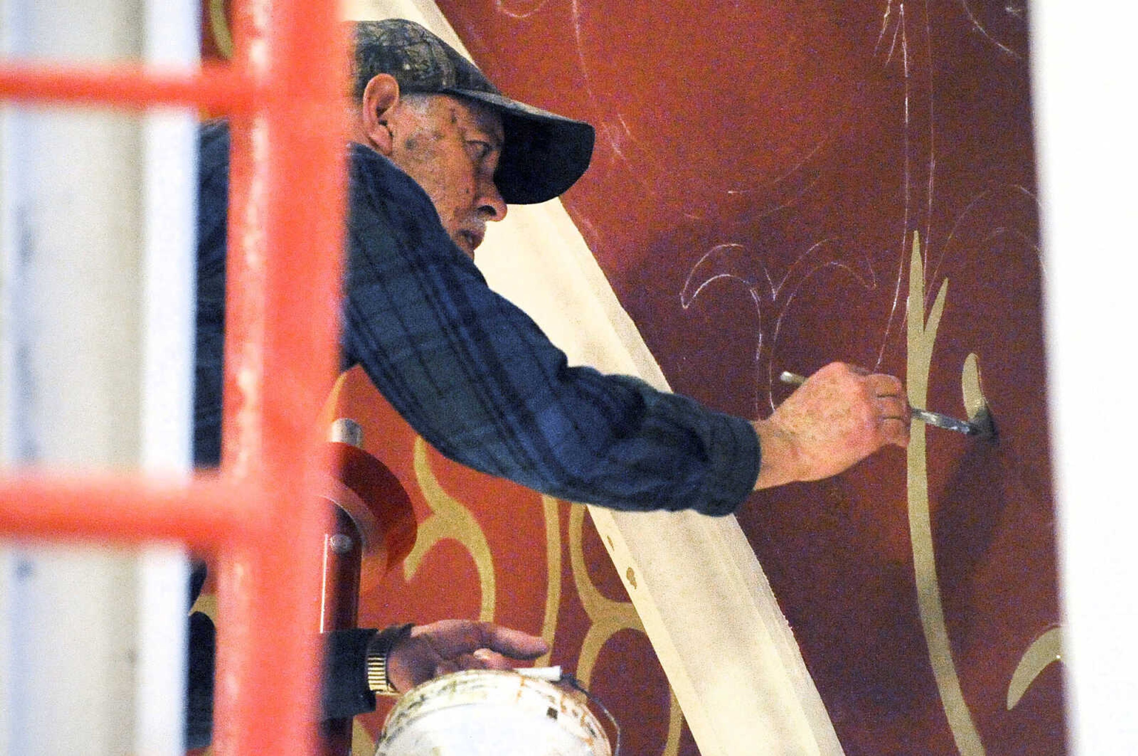 LAURA SIMON ~ lsimon@semissourian.com

Gary West paints gold over the stenciling on the ceiling above the tabernacle area of St. John's Catholic Church in Leopold, Missouri on March 4, 2016.